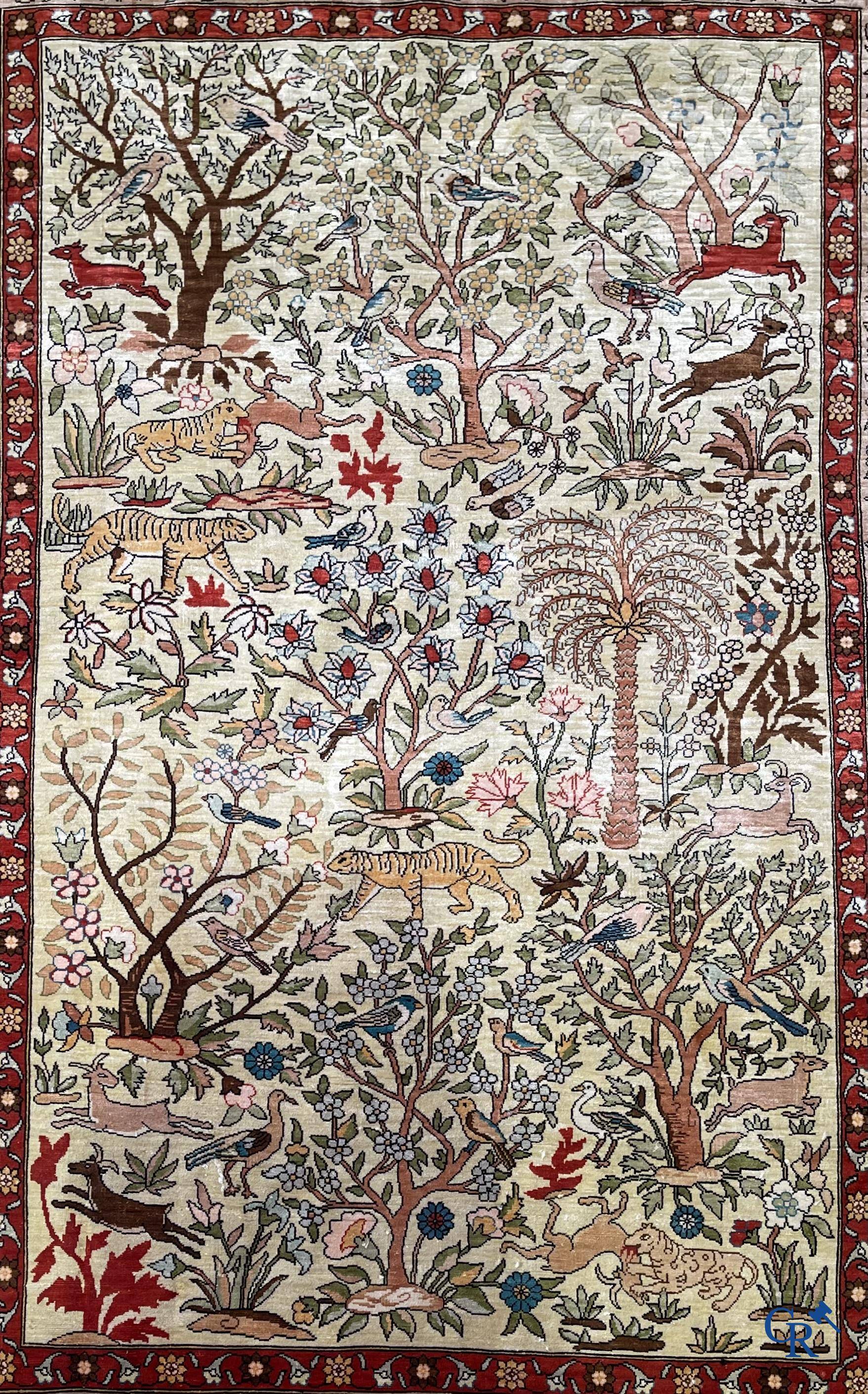 Oriental rugs, a fine hand-knotted silk tapestry with animals in a forest. Signed.