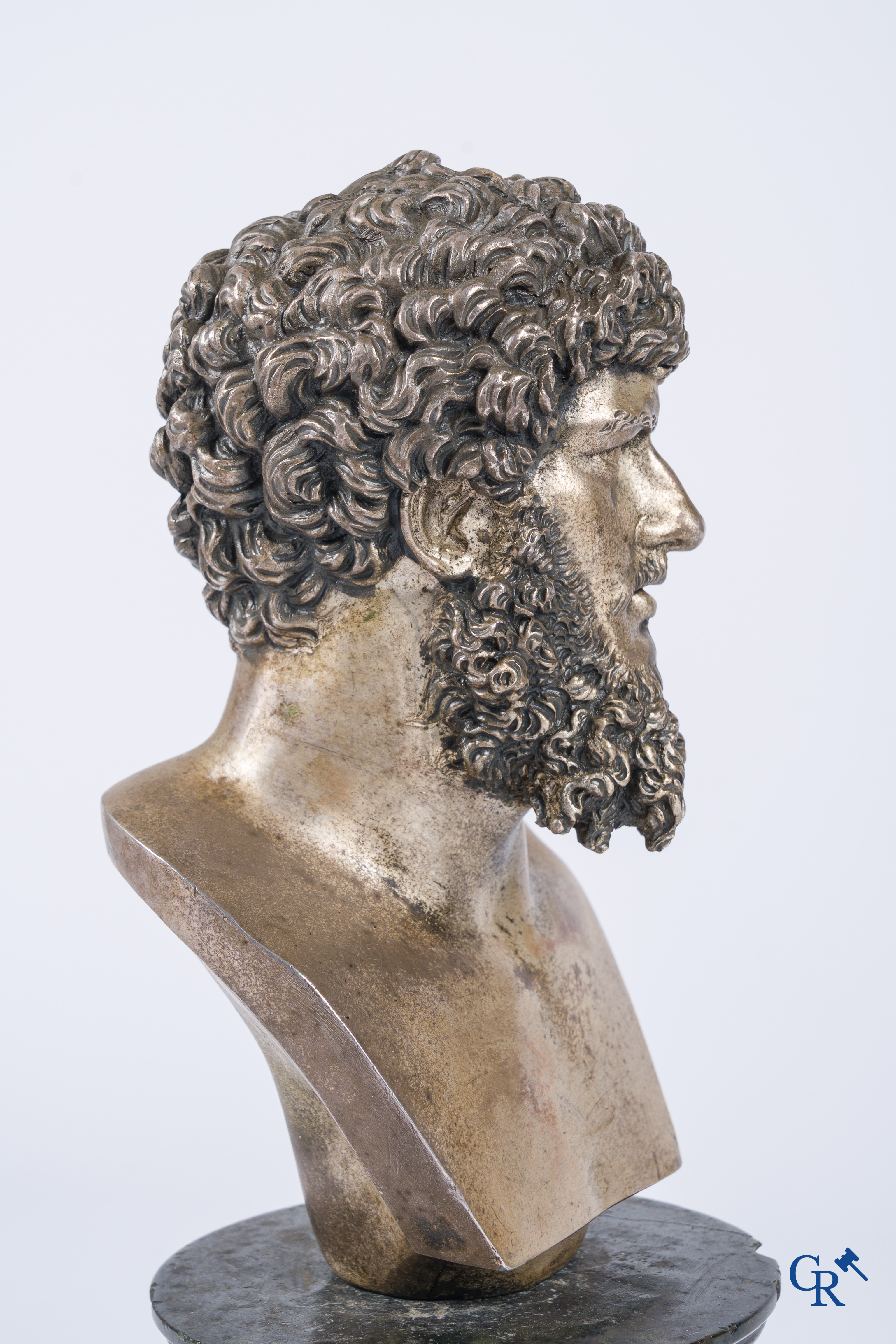 A silvered bronze bust of Lucius Verus on a dark green serpentine pedestal. 19th century.