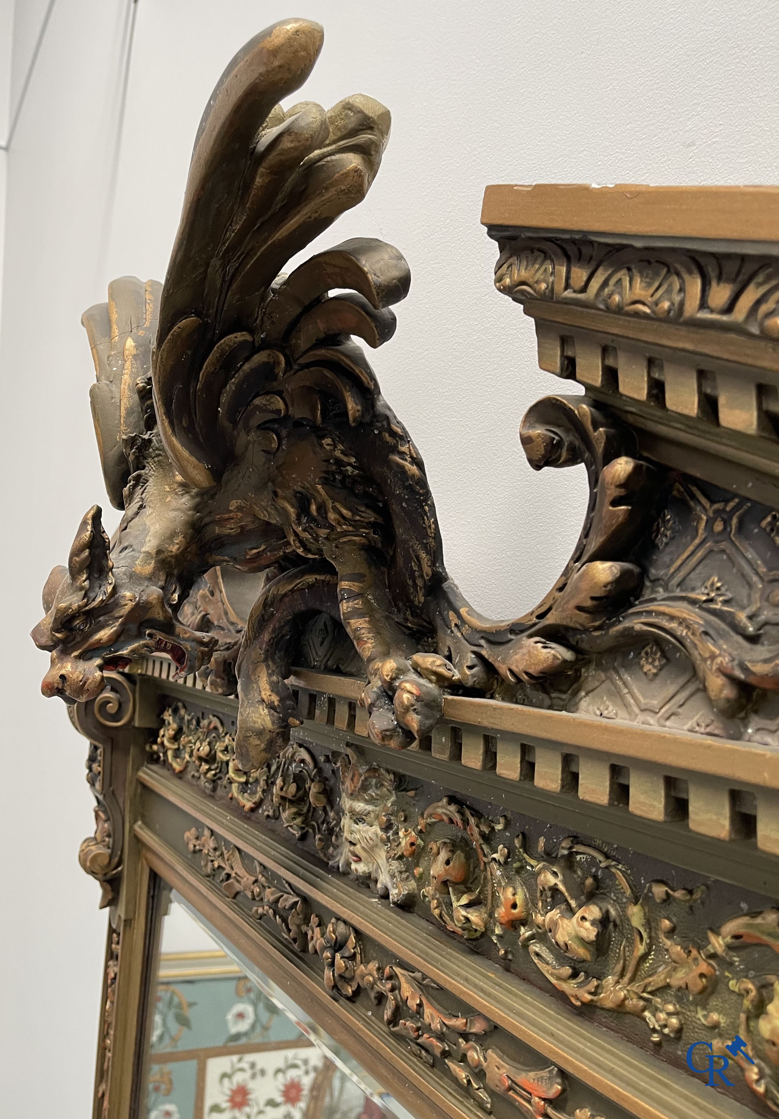 A large patinated fireplace mirror with a dragon. Around 1900.