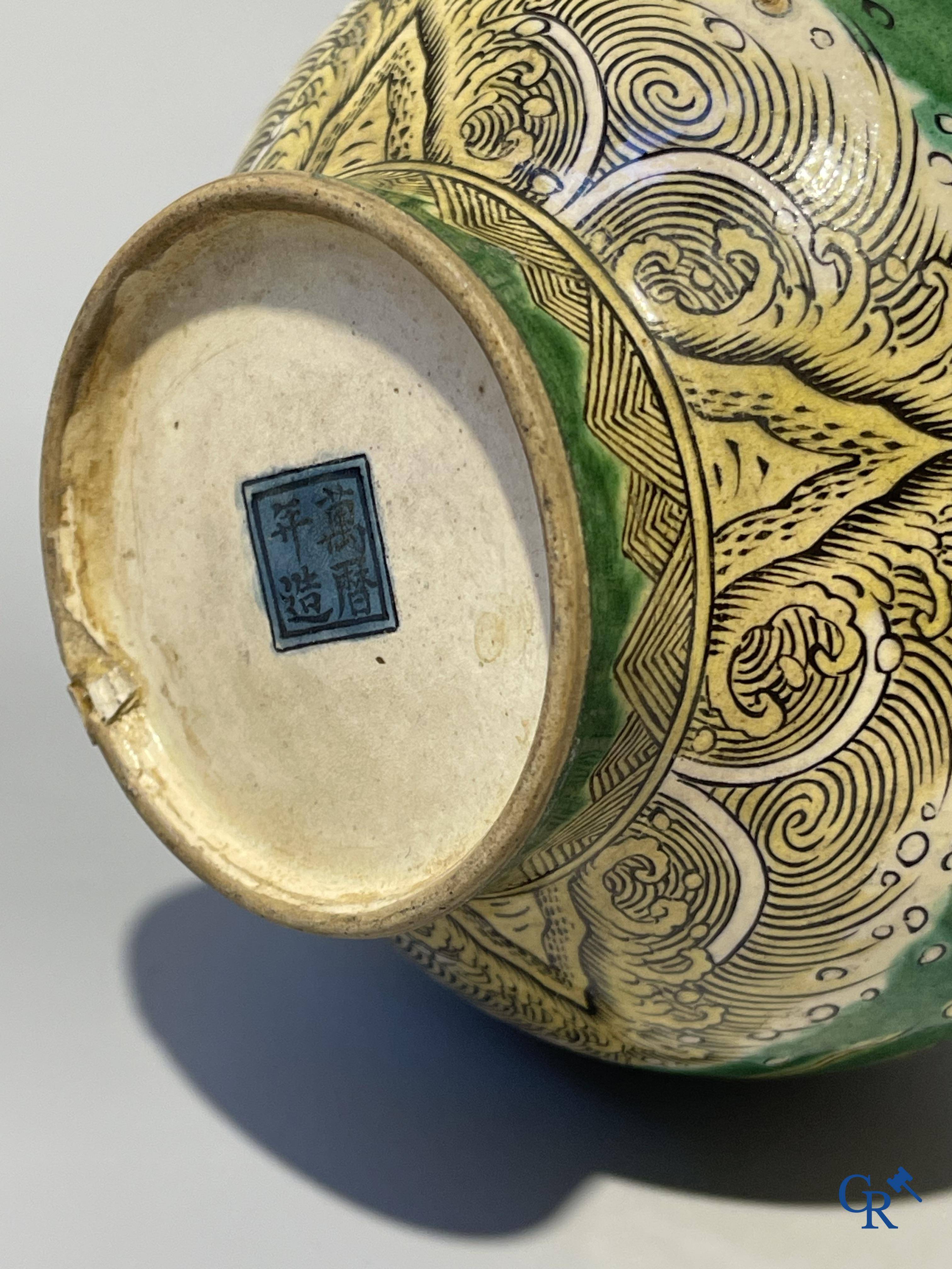 Asian Art, A fine Chinese green and yellow biscuit vase with dragon decor. Marked.