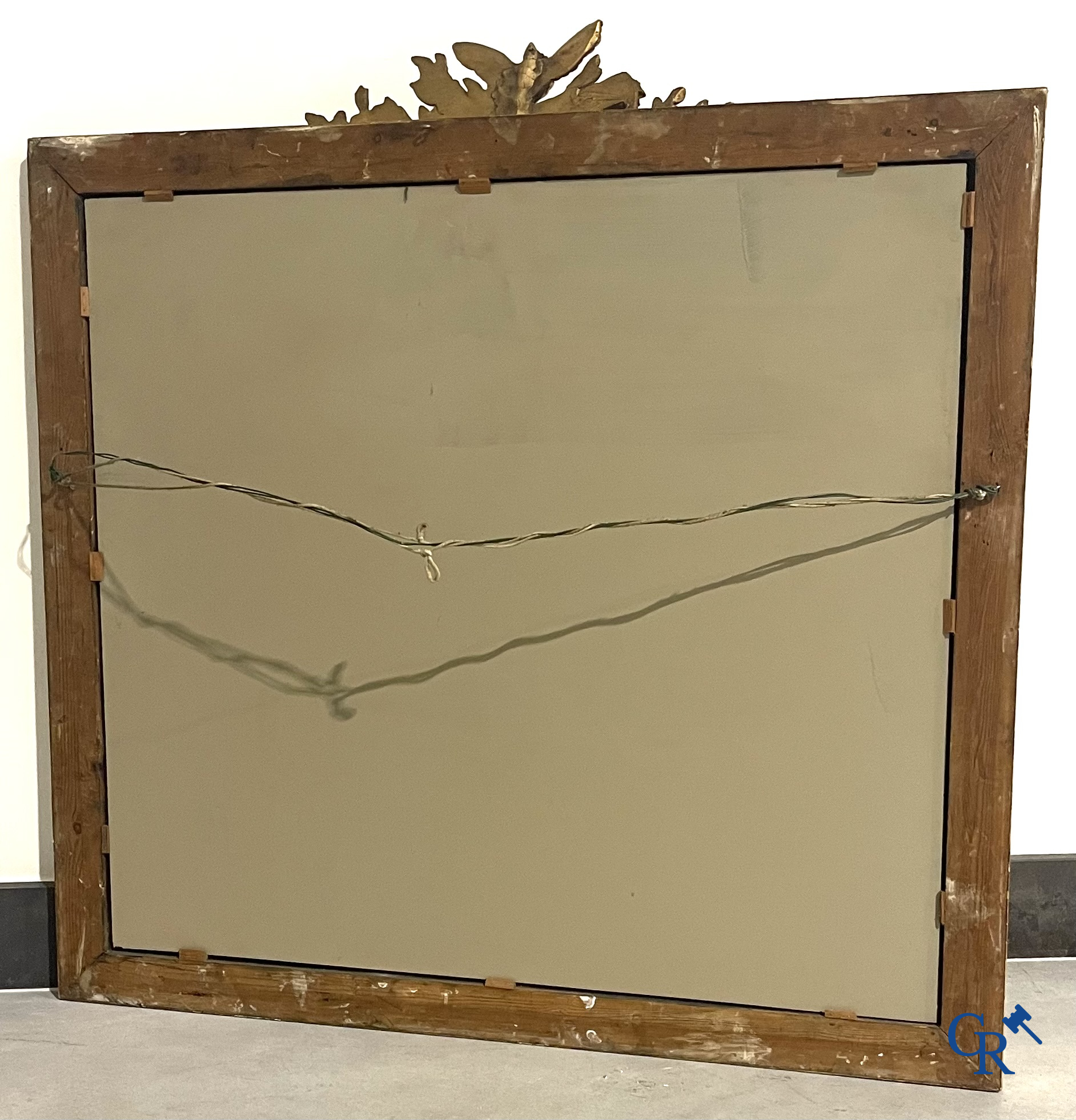 A large gilded fireplace mirror in LXVI style. Circa 1920.