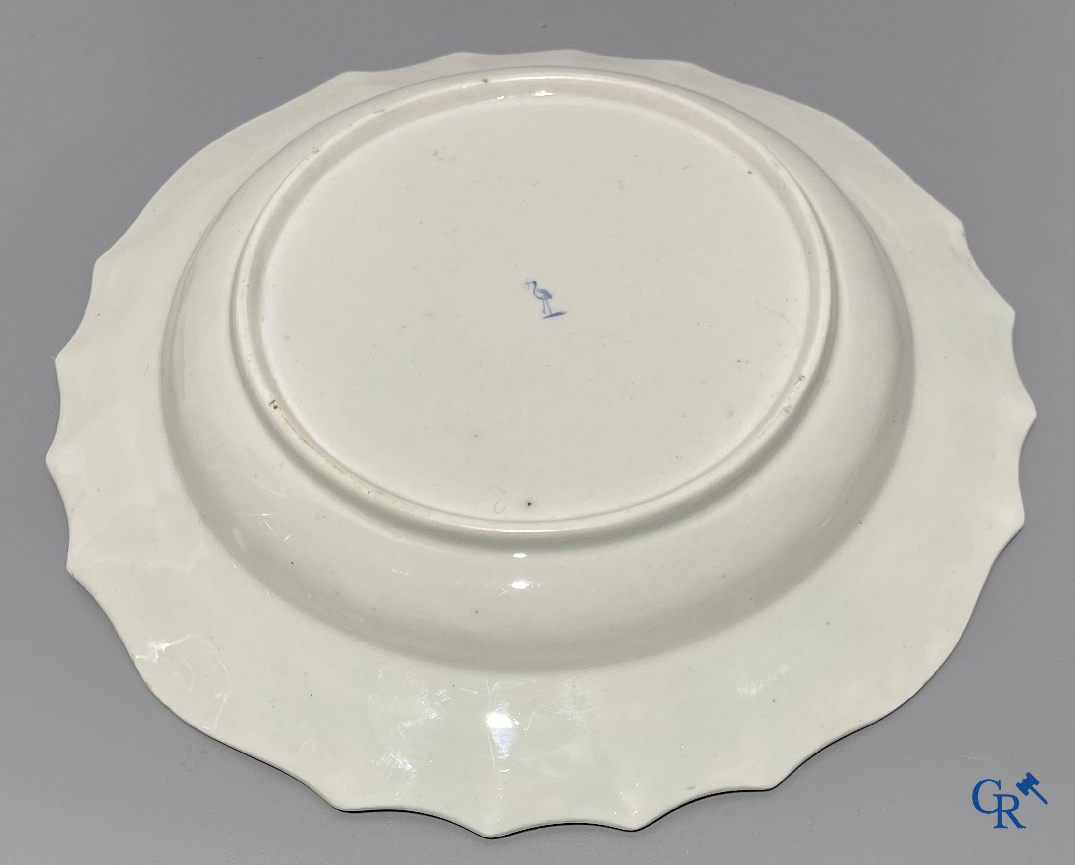 European porcelain, Tournai. 2 plates with a polychrome decoration of birds and gold decoration in The Hague. 18th century.