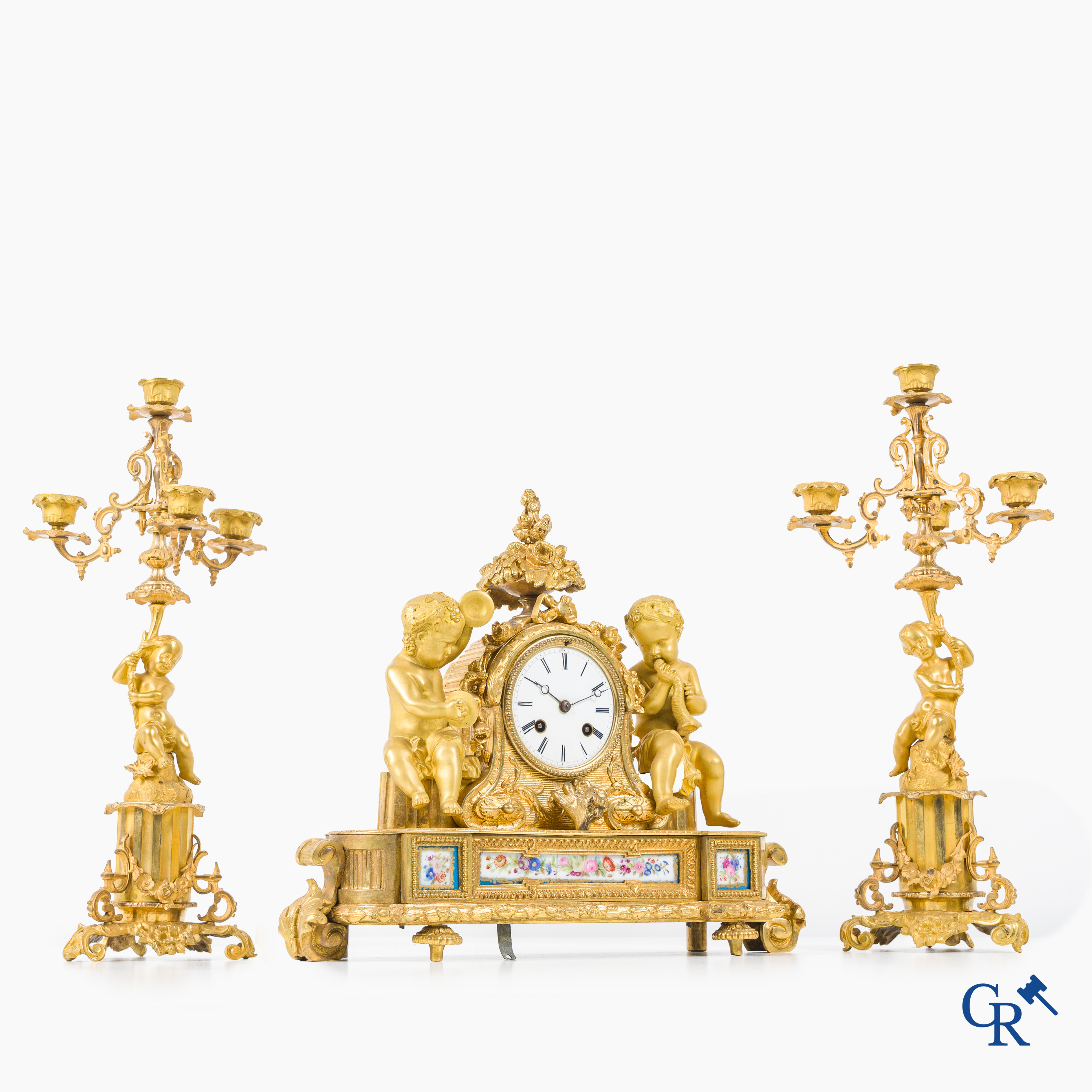 A 3-piece gilded bronze fireplace clockset with Sèvres porcelain.
