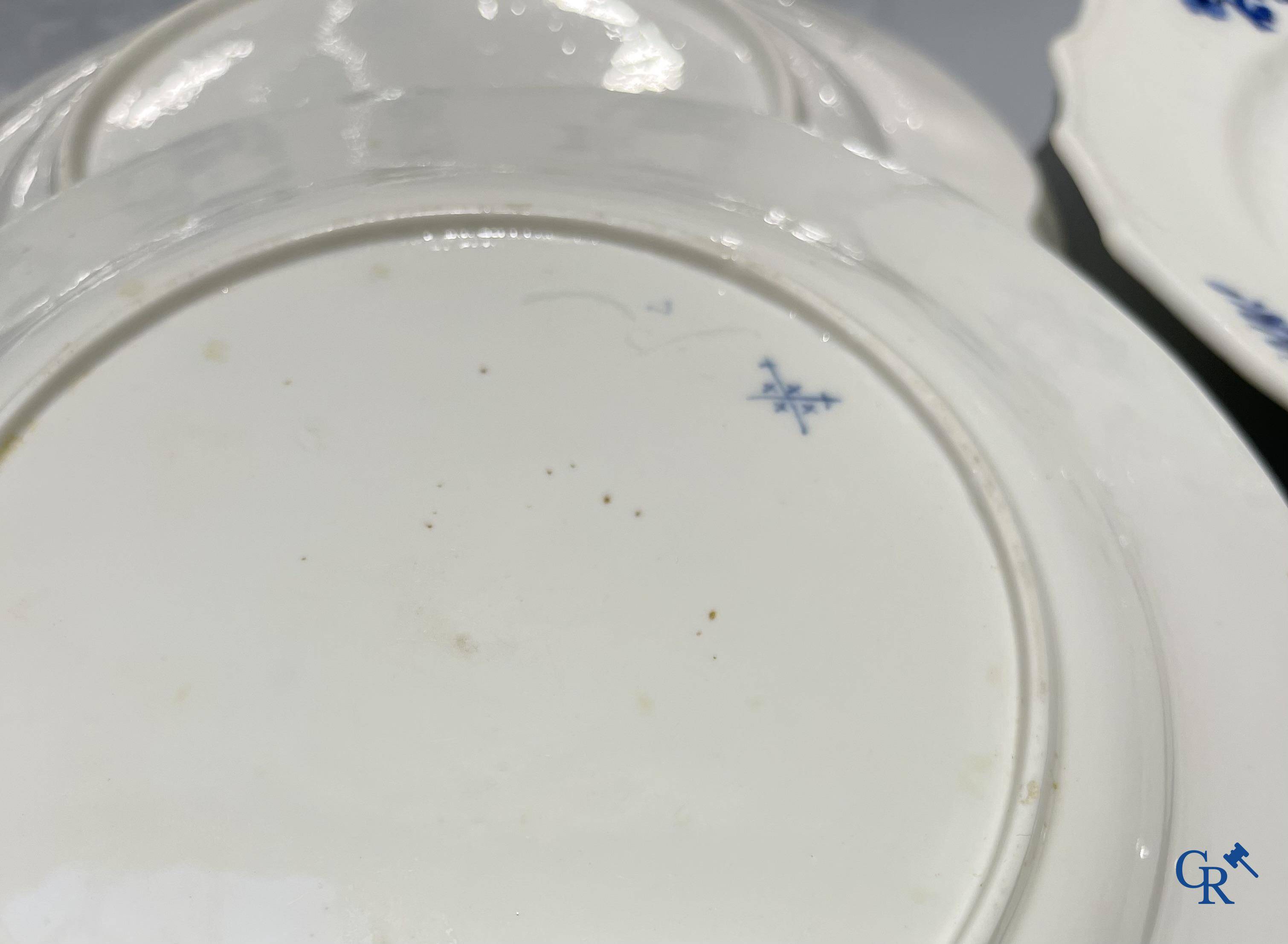 European porcelain, Tournai. 13 plates with blue decor and a large monochrome dish. 18th century.