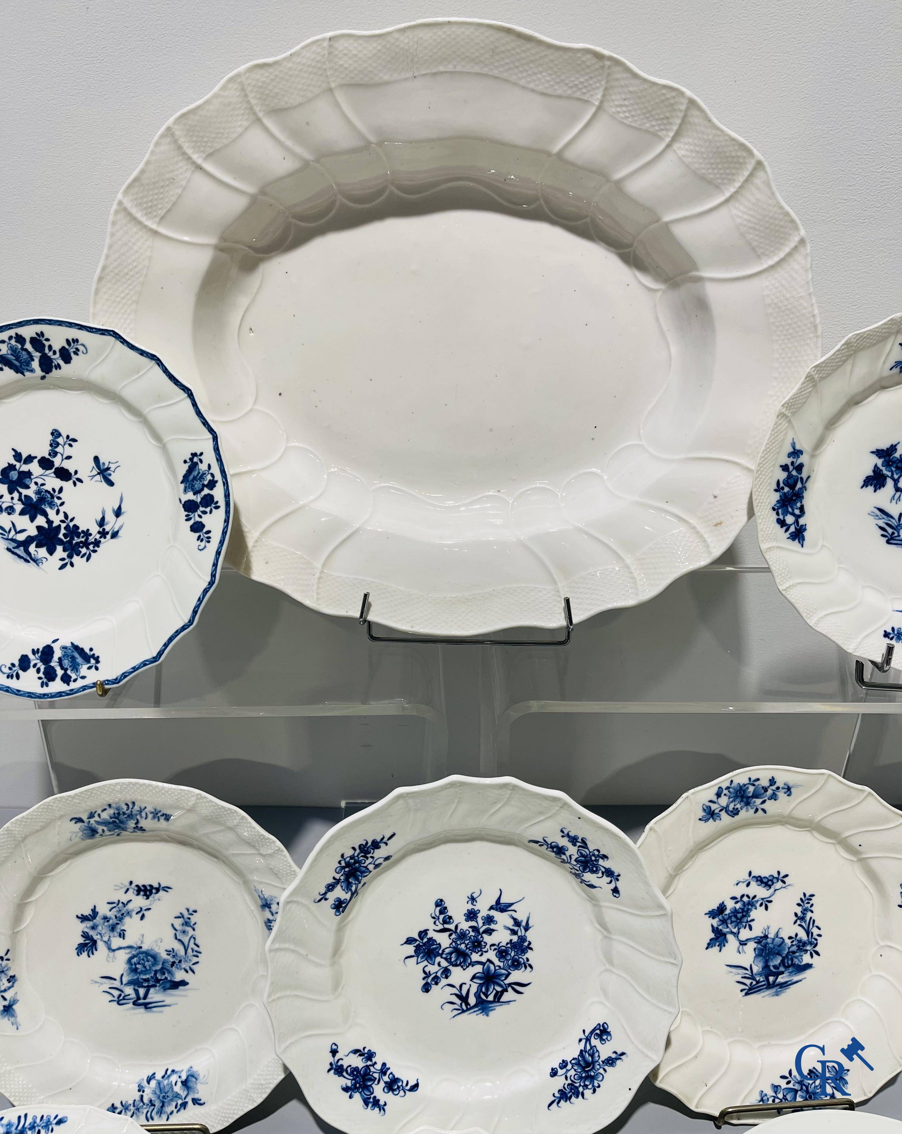 European porcelain, Tournai. 13 plates with blue decor and a large monochrome dish. 18th century.
