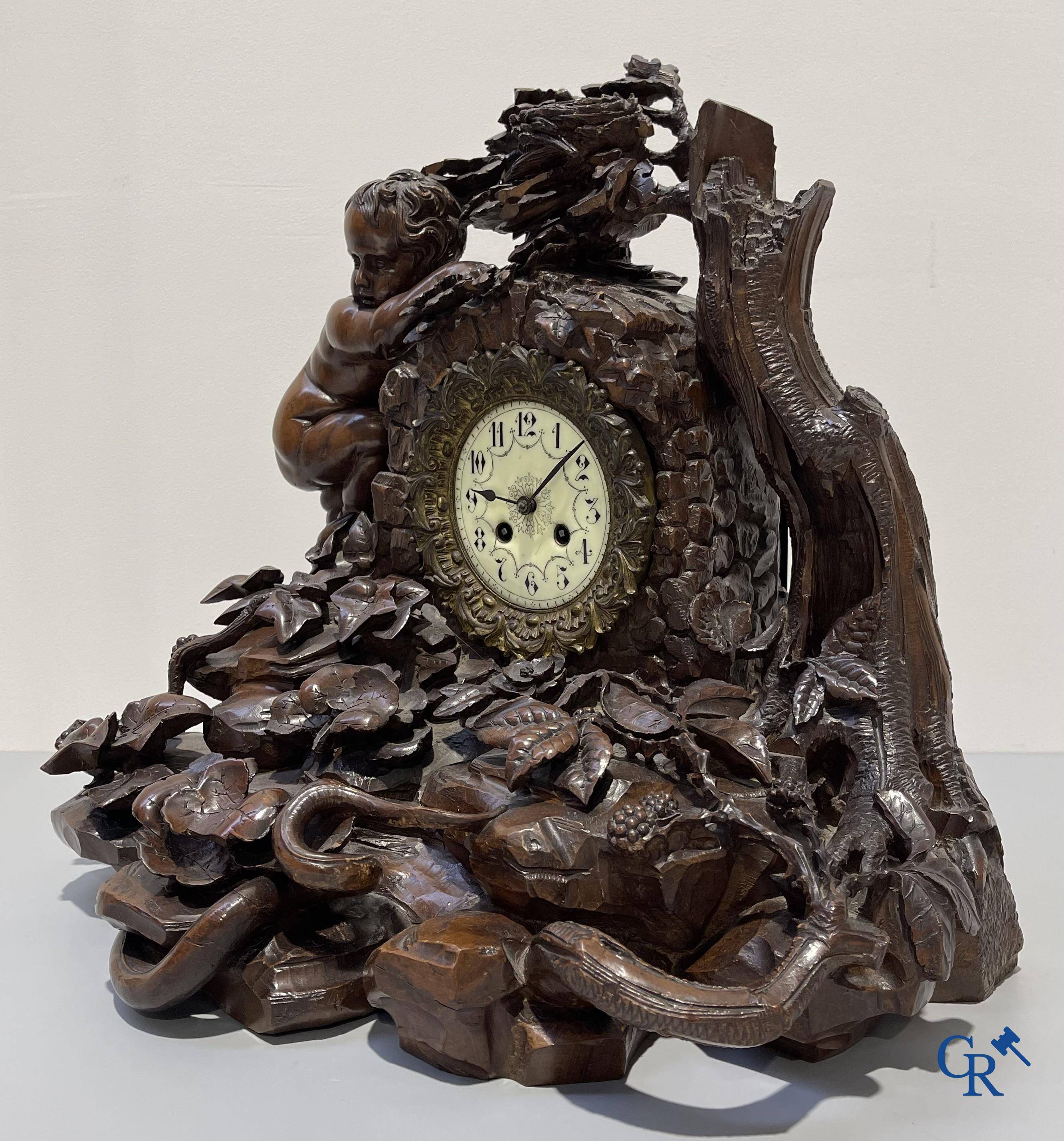 A finely carved walnut clock in so-called "black forest" carving. French work circa 1860-1880.