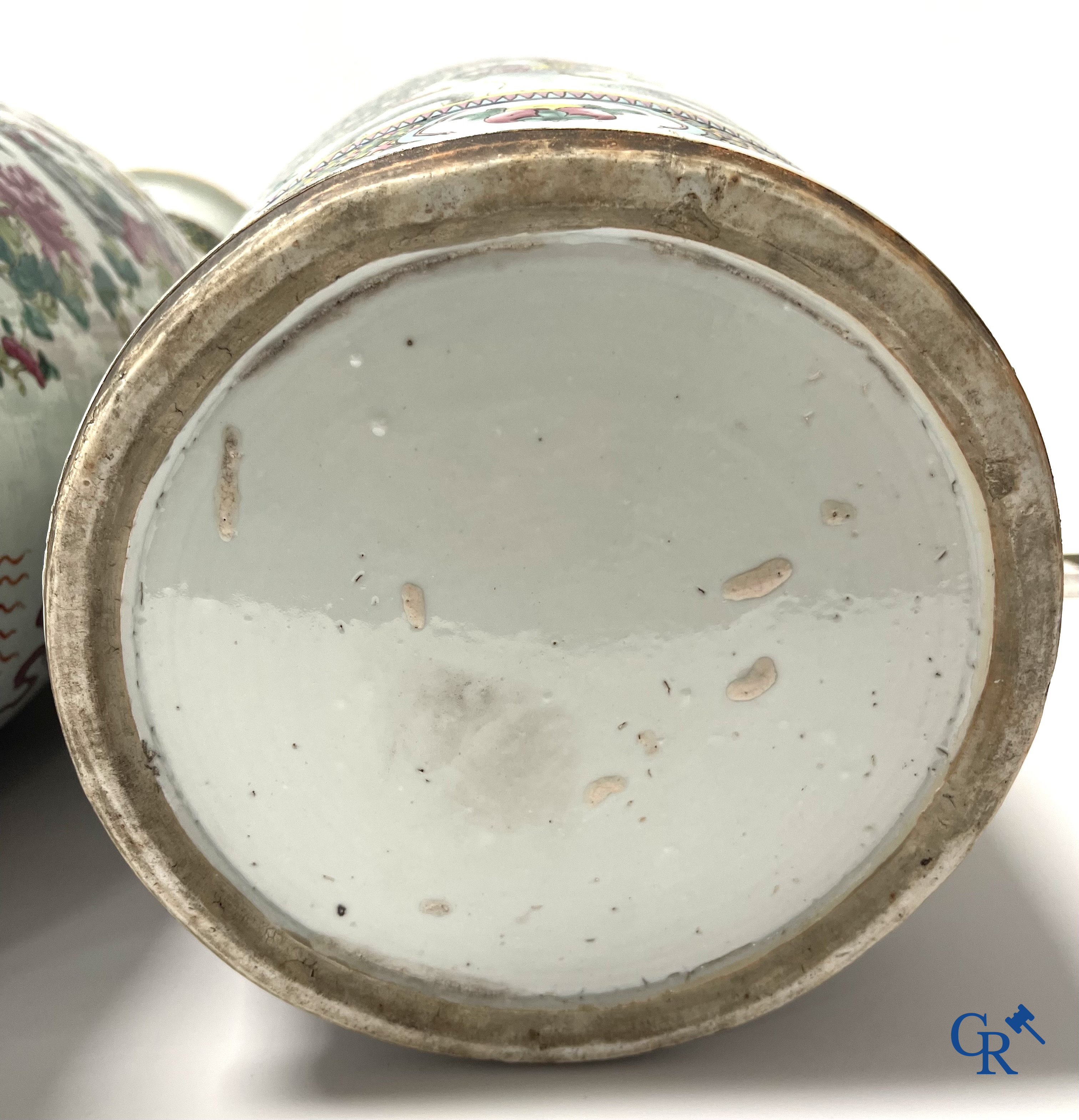 Asian Art, A pair of Chinese famille rose vases with peacocks and Fo dogs. 19th century.