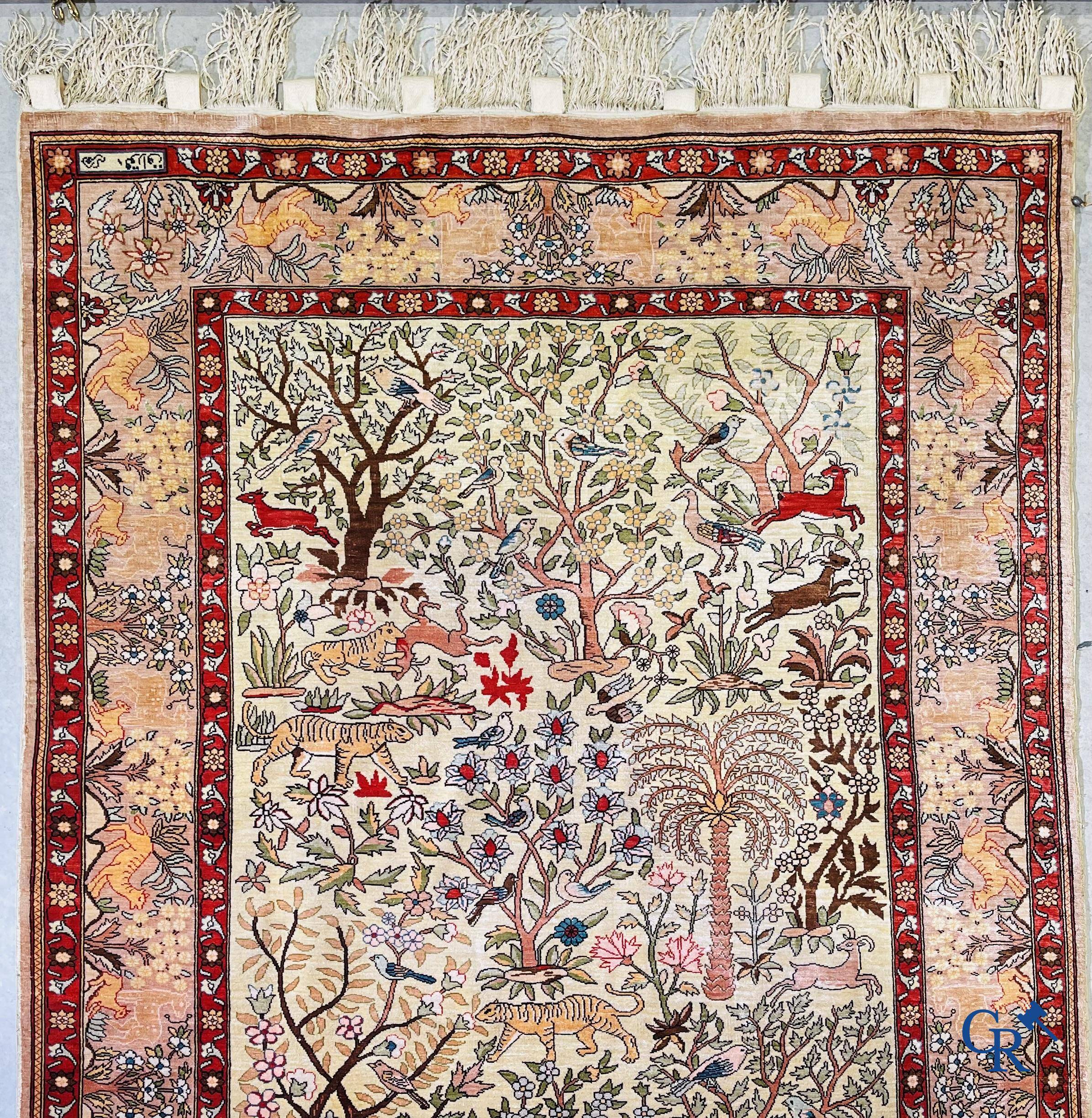 Oriental rugs, a fine hand-knotted silk tapestry with animals in a forest. Signed.