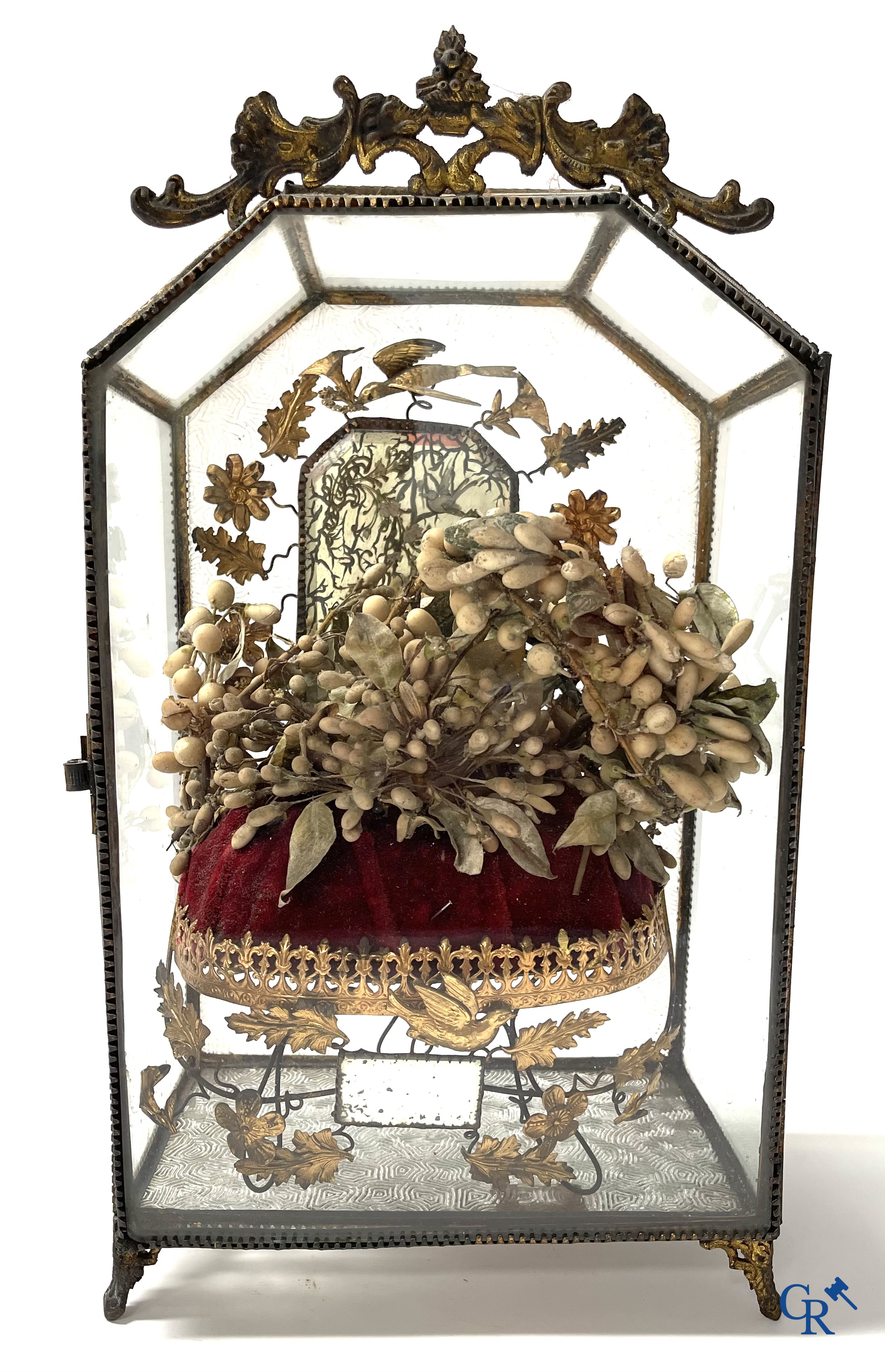 A globe in glass with a child in wax and a brass display case with bridal bouquet. Around 1900.