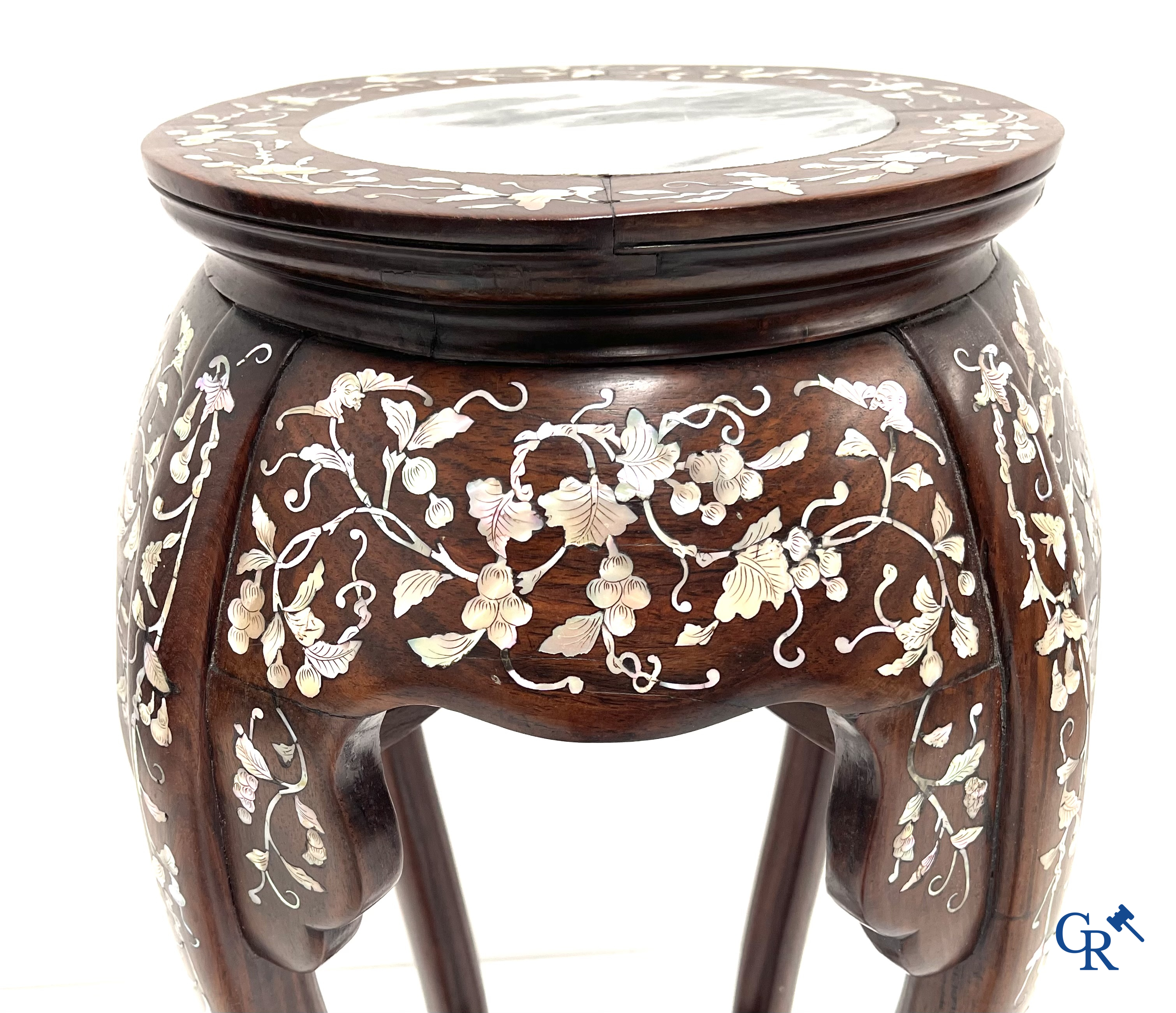An Oriental wooden pedestal inlaid with mother-of-pearl.