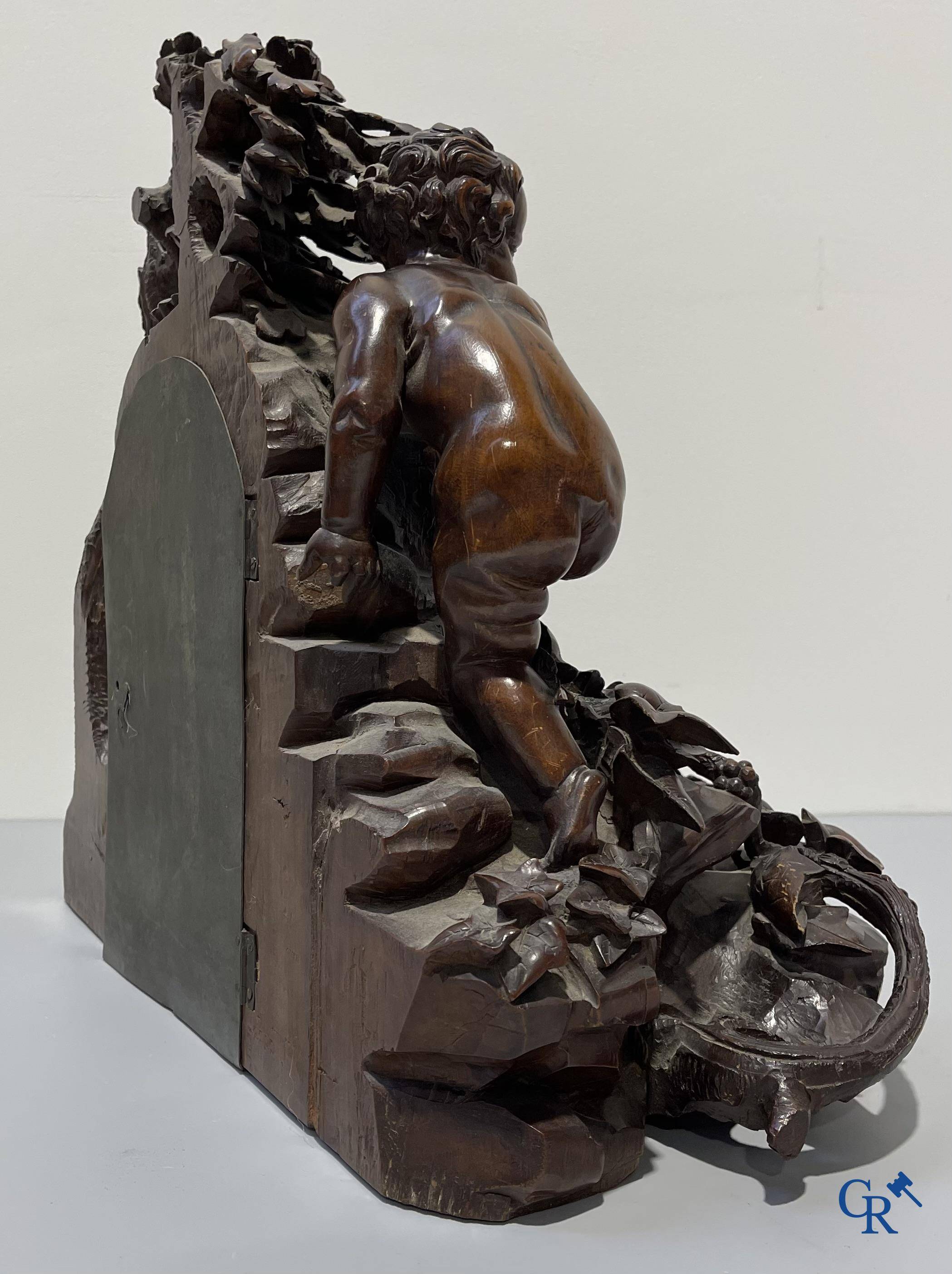 A finely carved walnut clock in so-called "black forest" carving. French work circa 1860-1880.