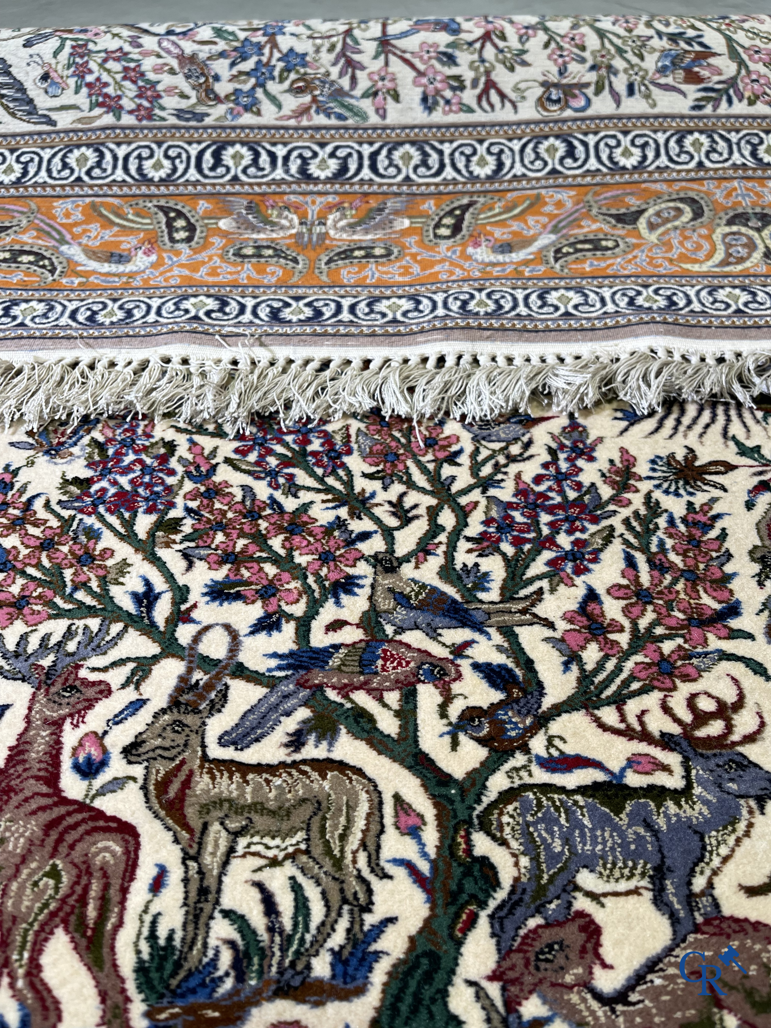 Oriental carpets, a finely hand-knotted silk carpet with forest animals. Signed.