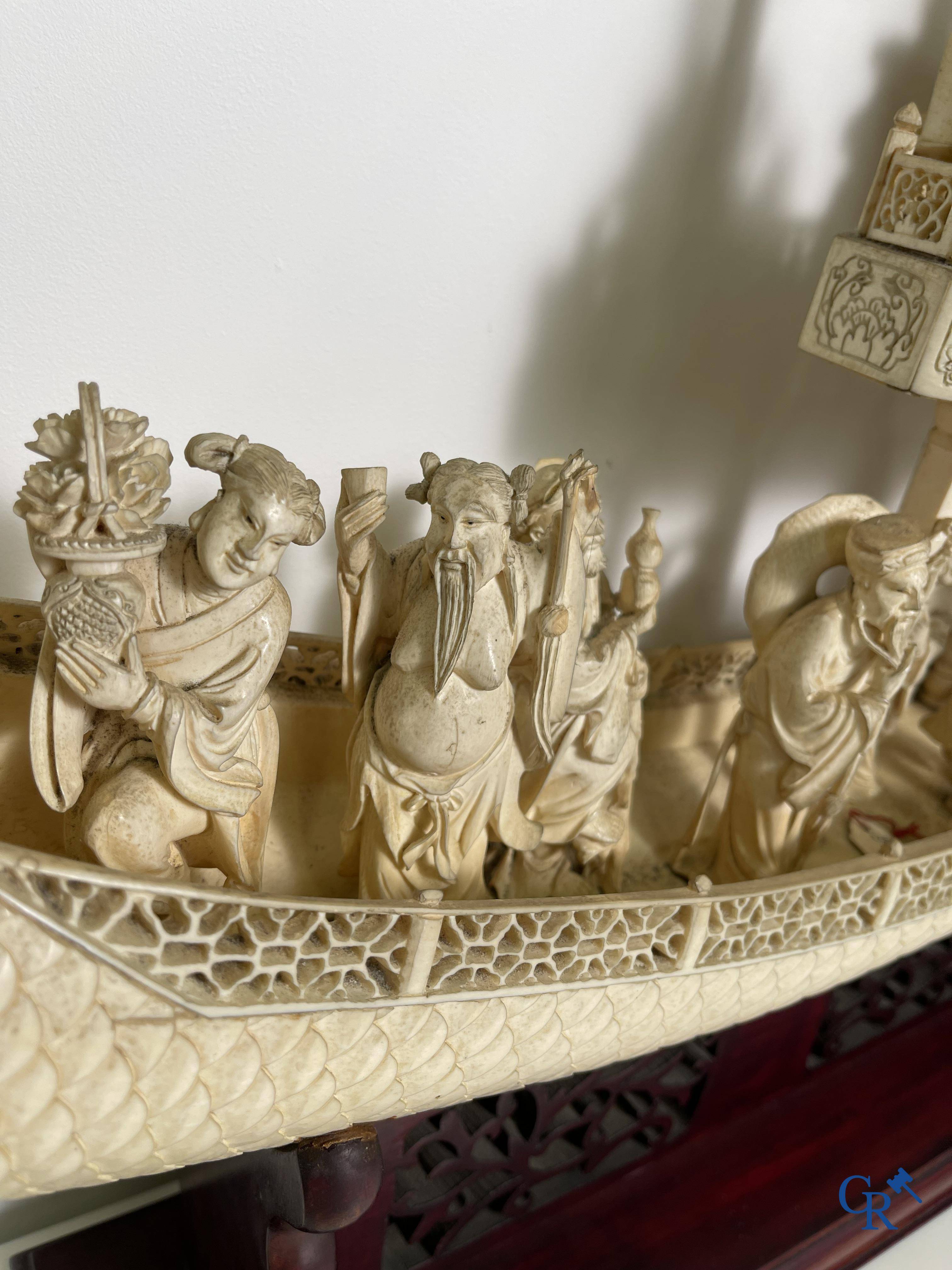 Asian Art: A large Chinese ivory dragon boat on a wooden pedestal. 19th century.
