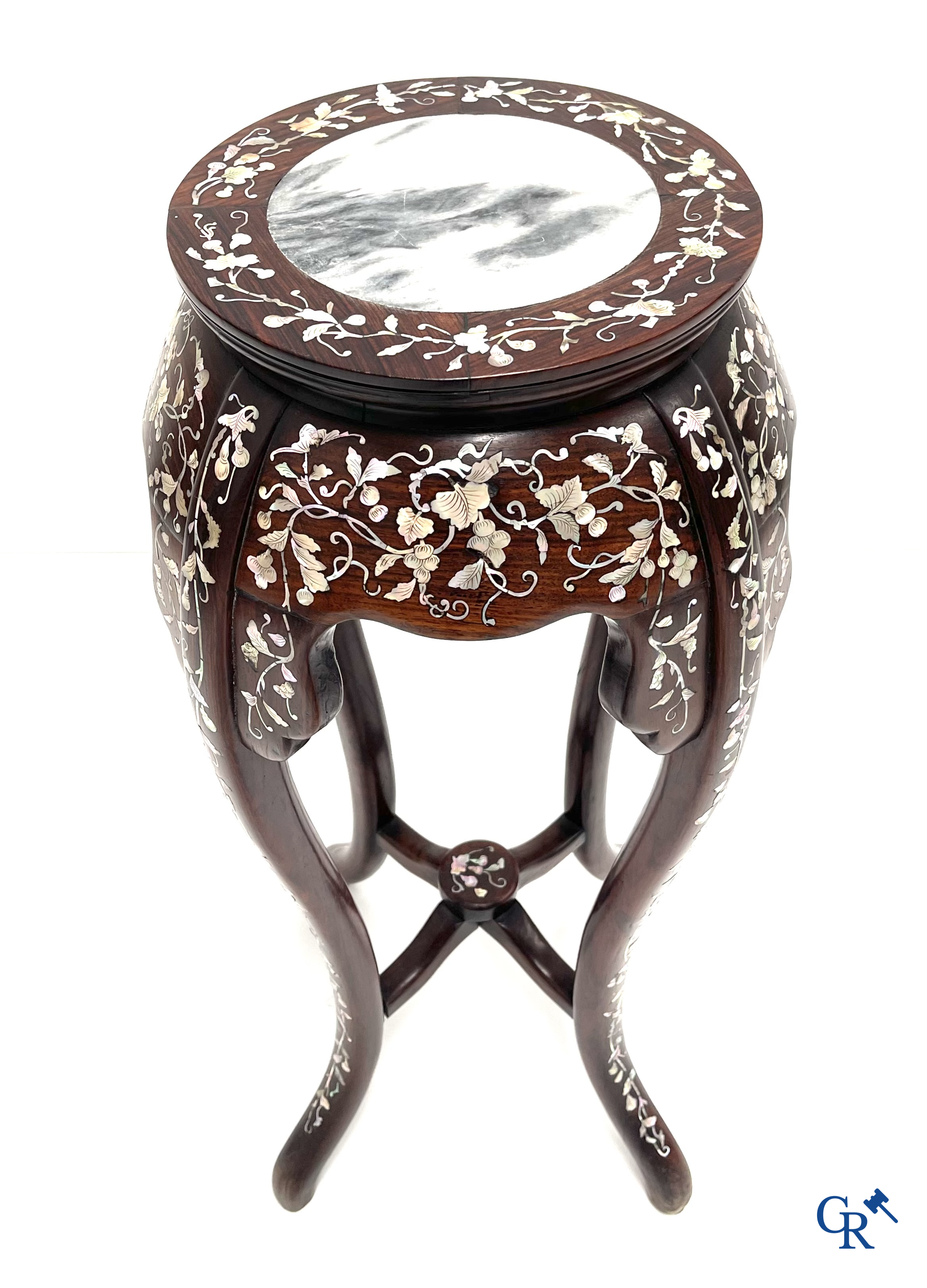 An Oriental wooden pedestal inlaid with mother-of-pearl.