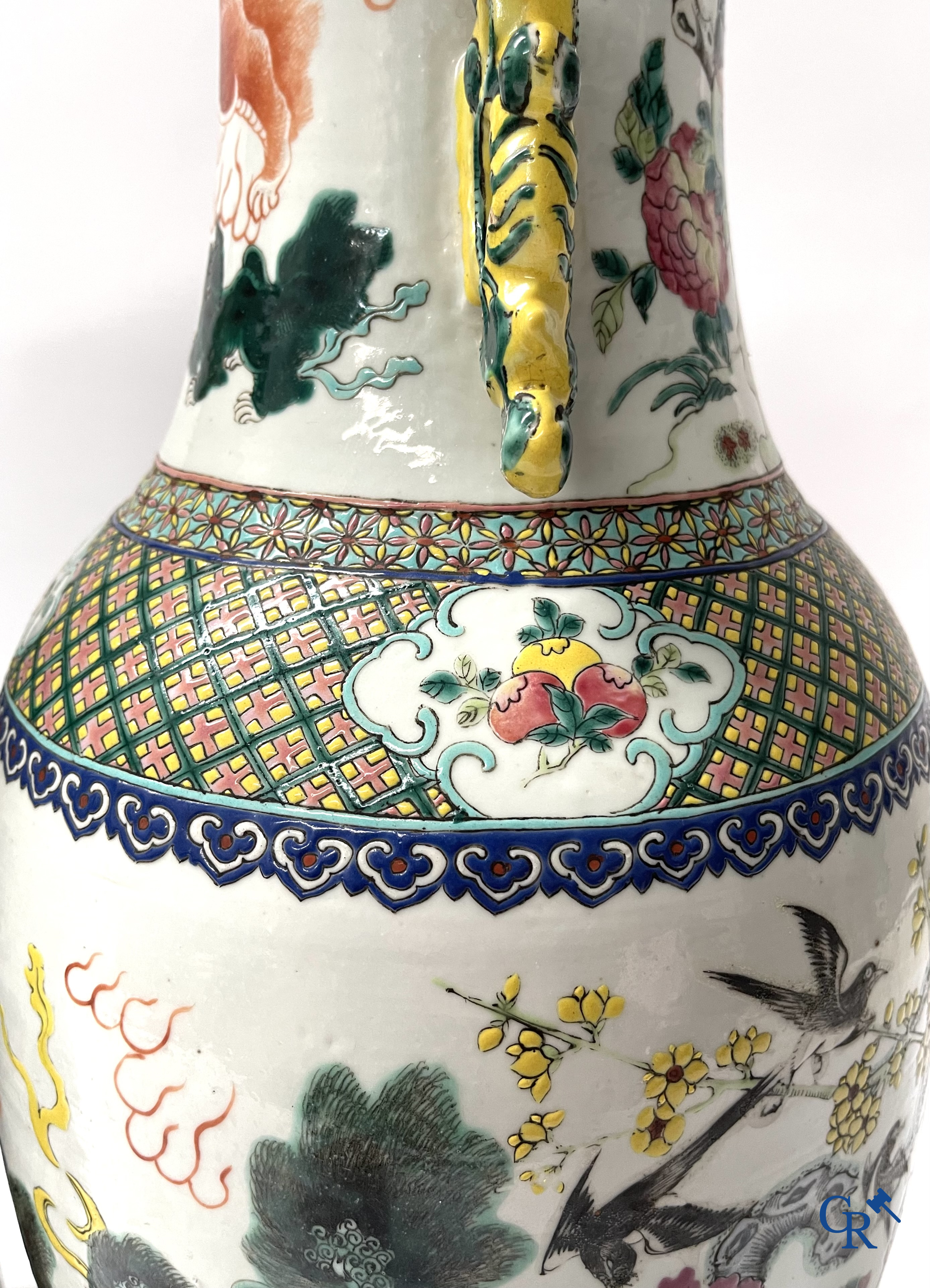 Asian Art, A pair of Chinese famille rose vases with peacocks and Fo dogs. 19th century.