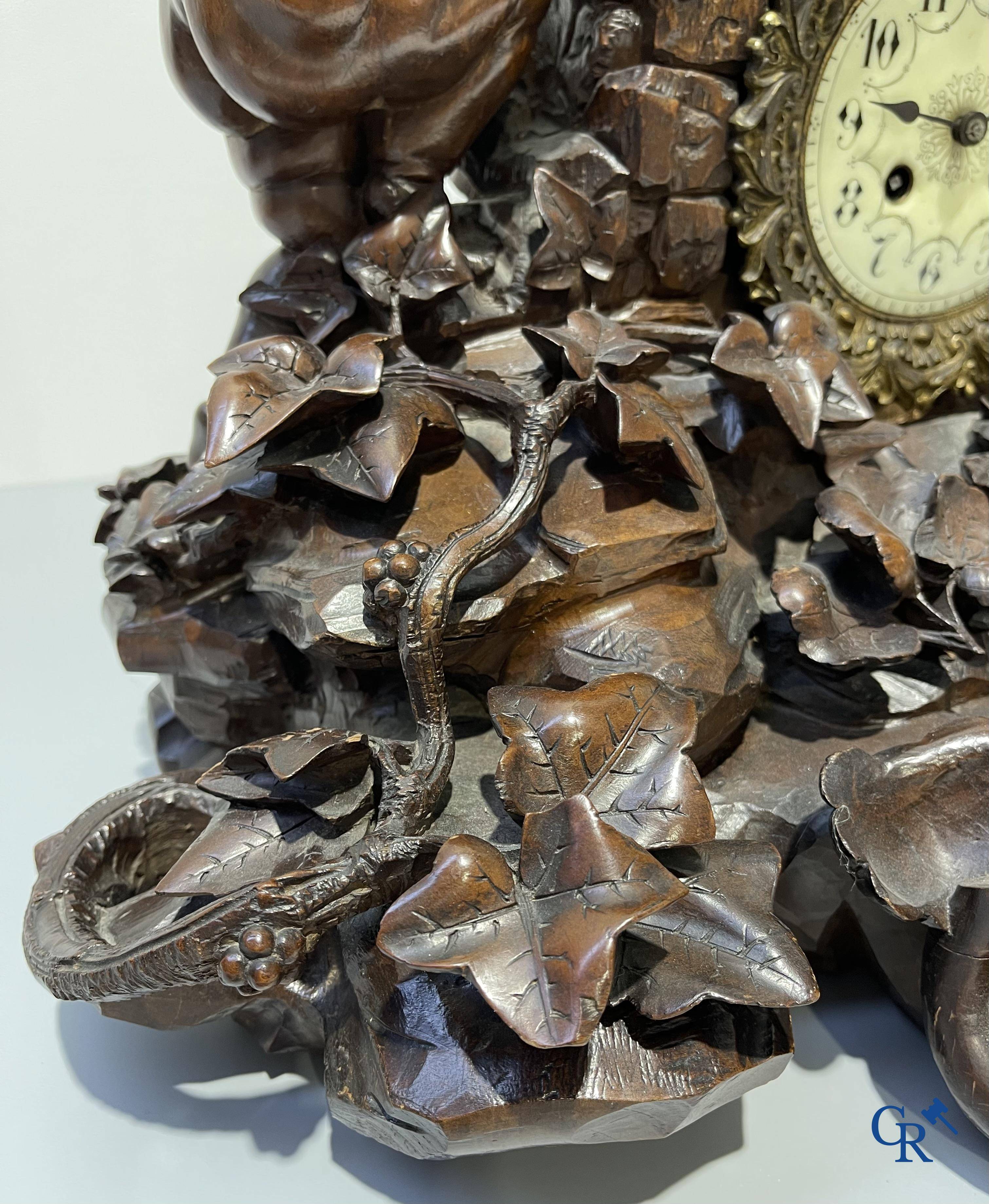 A finely carved walnut clock in so-called "black forest" carving. French work circa 1860-1880.