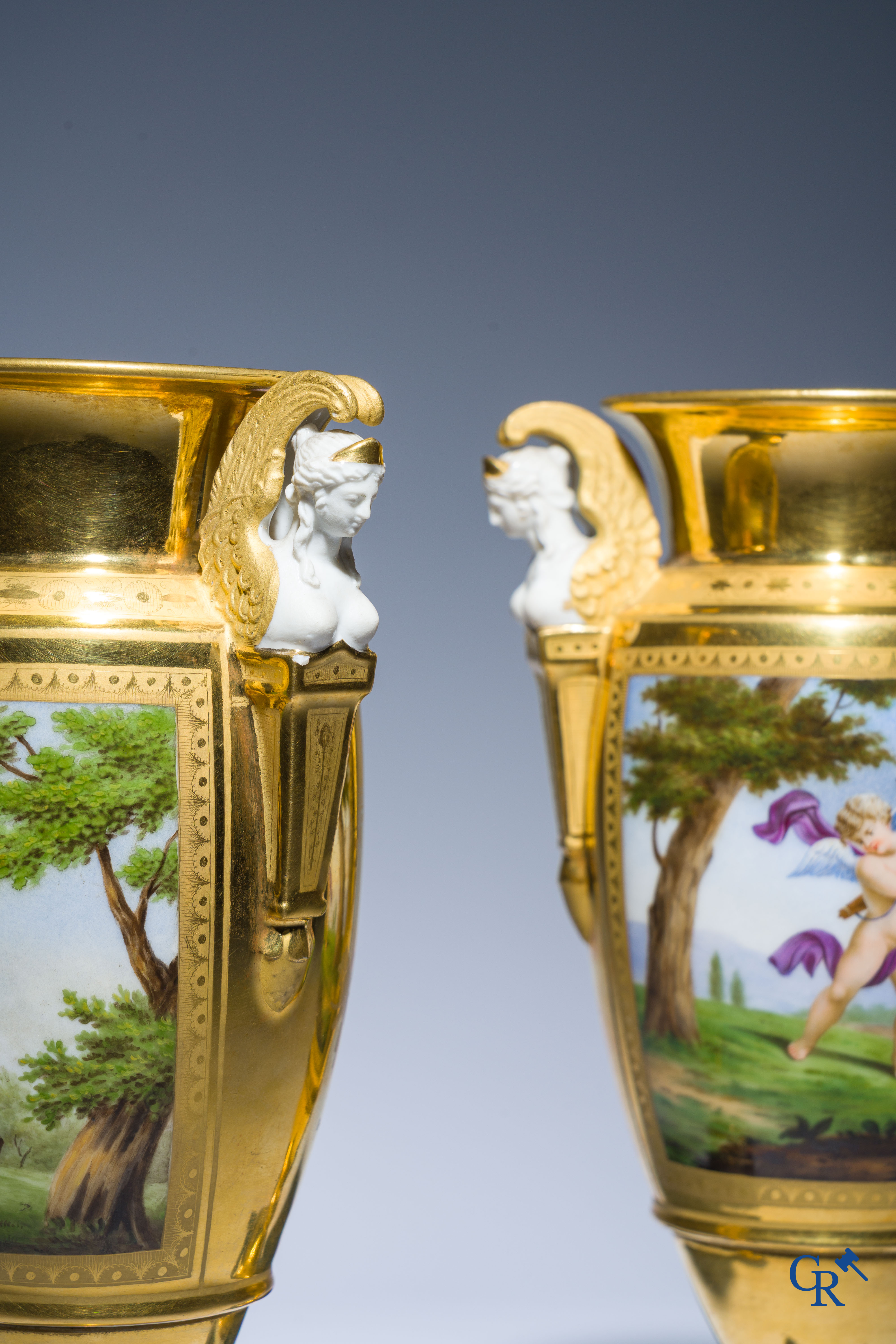 Empire, a pair of finely gilded and decorated vases in porcelain and biscuit on a marble pedestal, Circa 1810.
