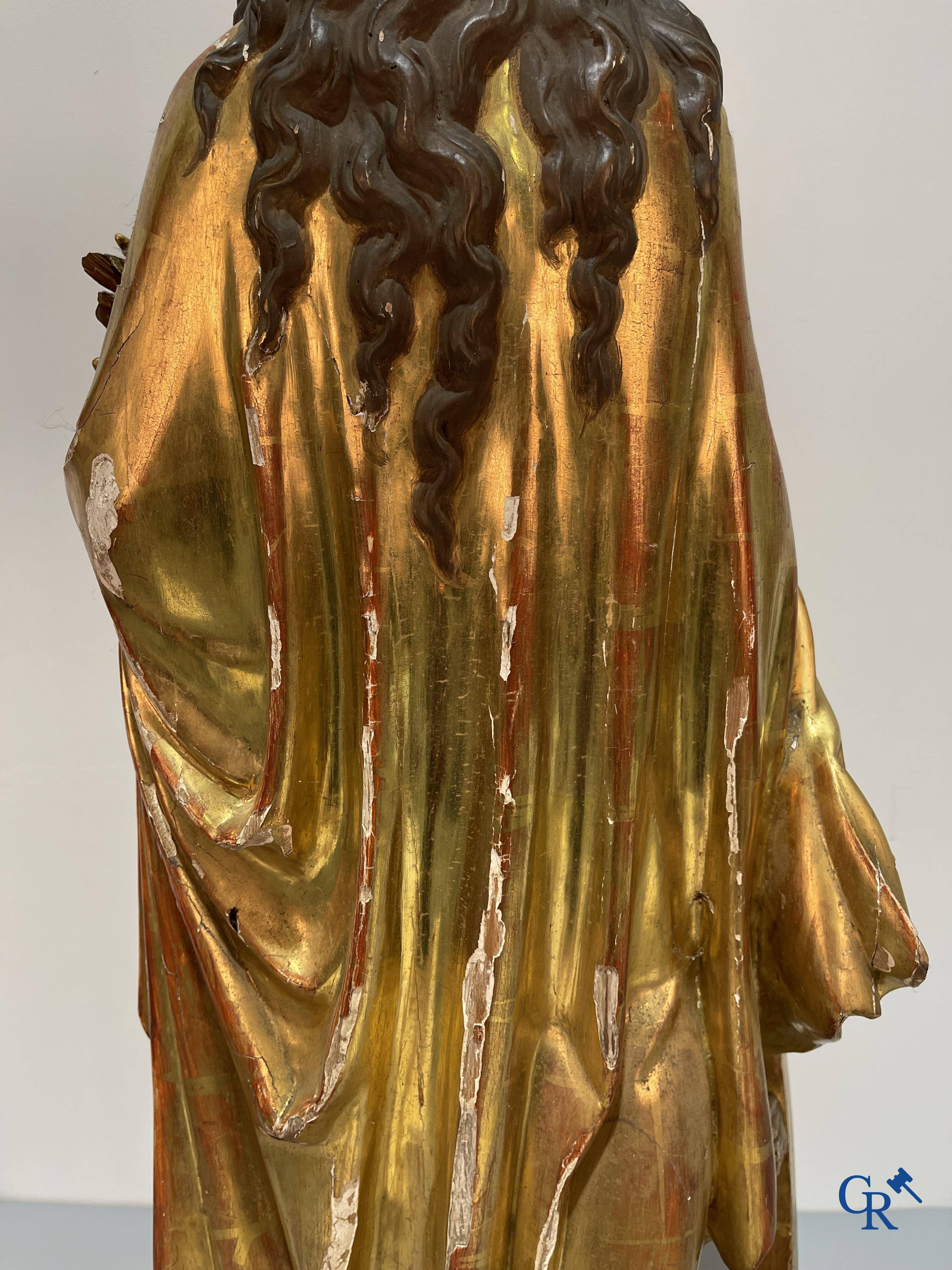 A large gilded and polychrome wooden statue of Saint Catherine of Alexandria.