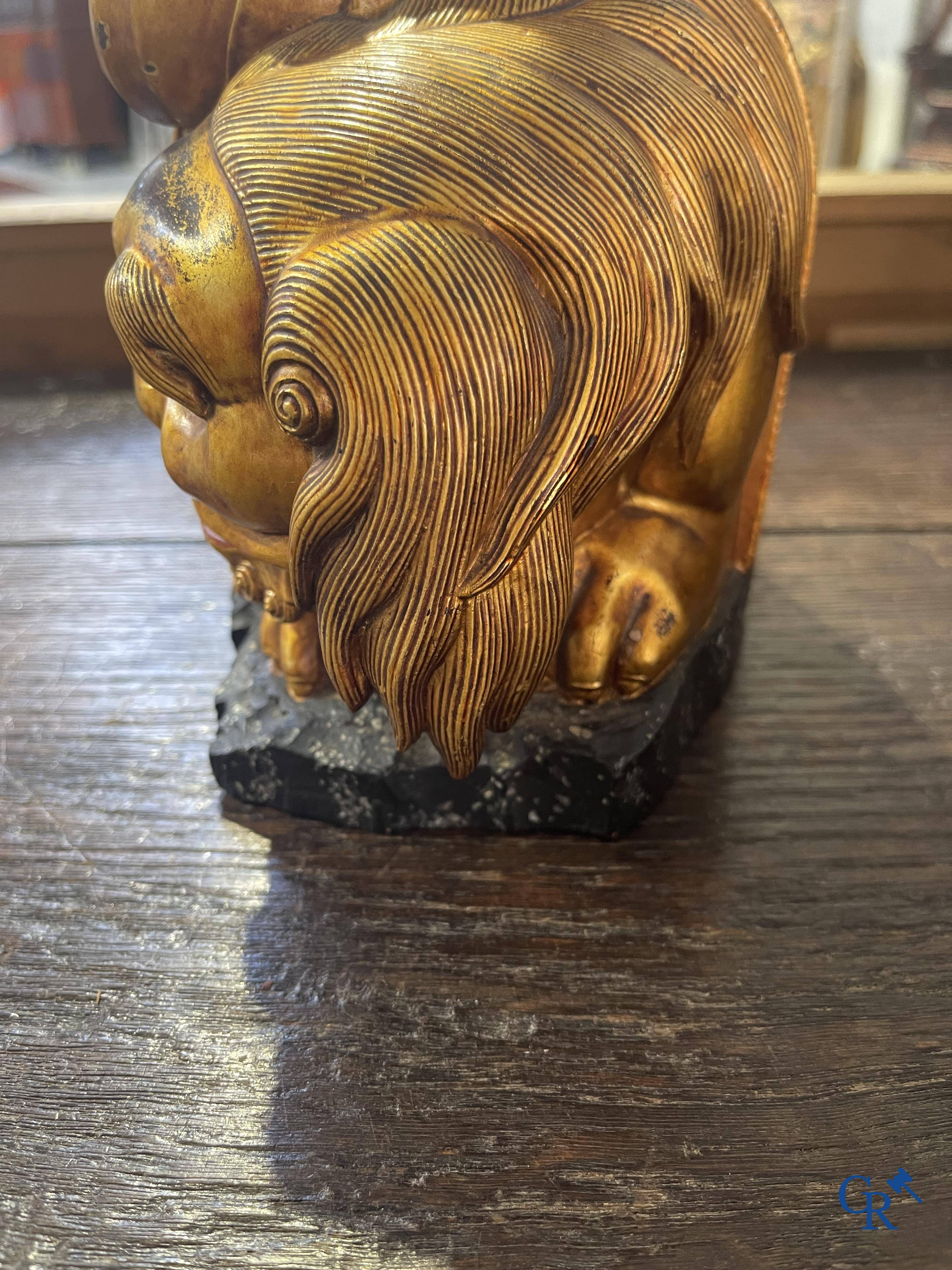 Asian Art: A Chinese sculpture of Vaishravana on a Buddhist lion in lacquered and gilded wood. 19th century.