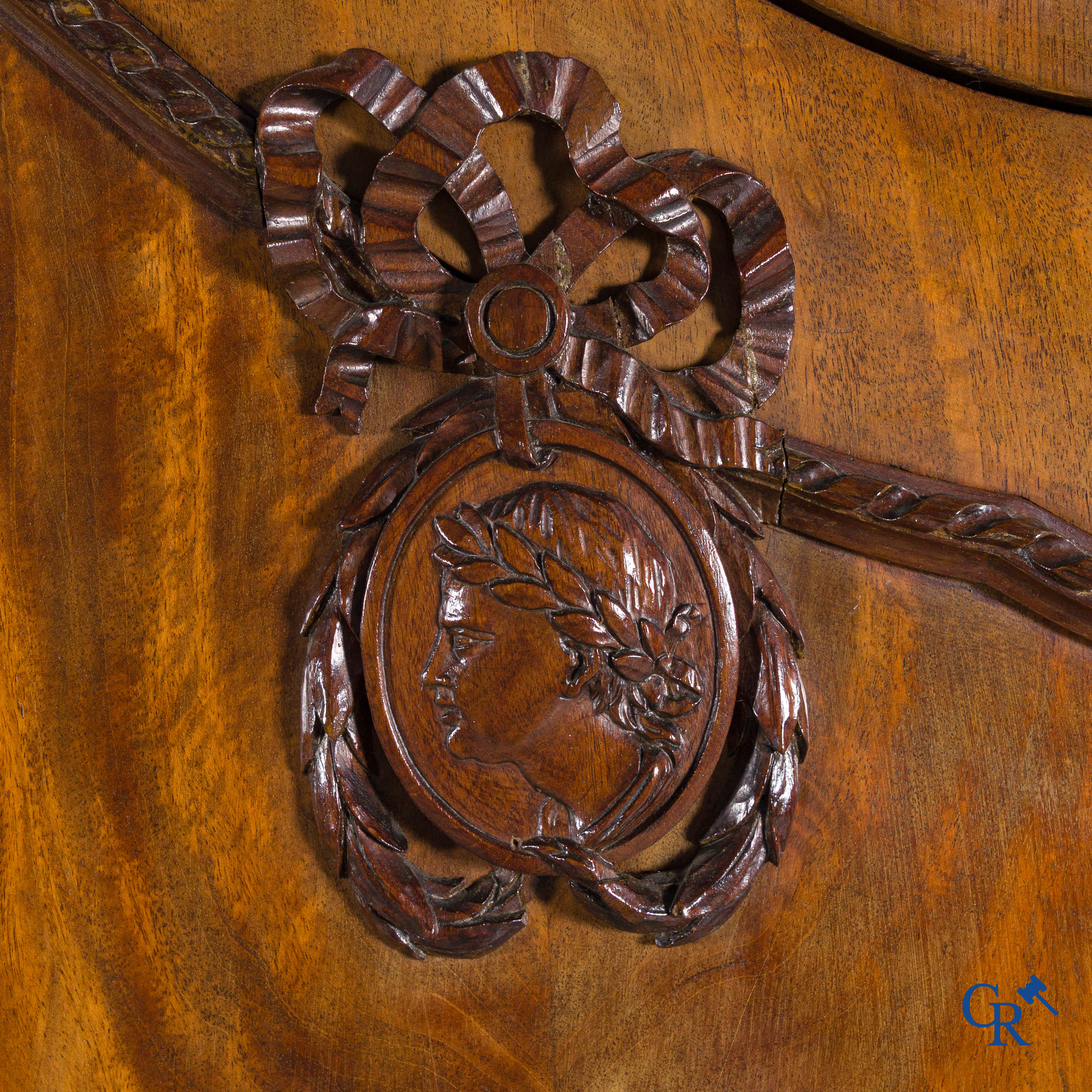 A large mahogany wooden cabinet with 3 drawers and 2 doors decorated with lockets. LXVI style.