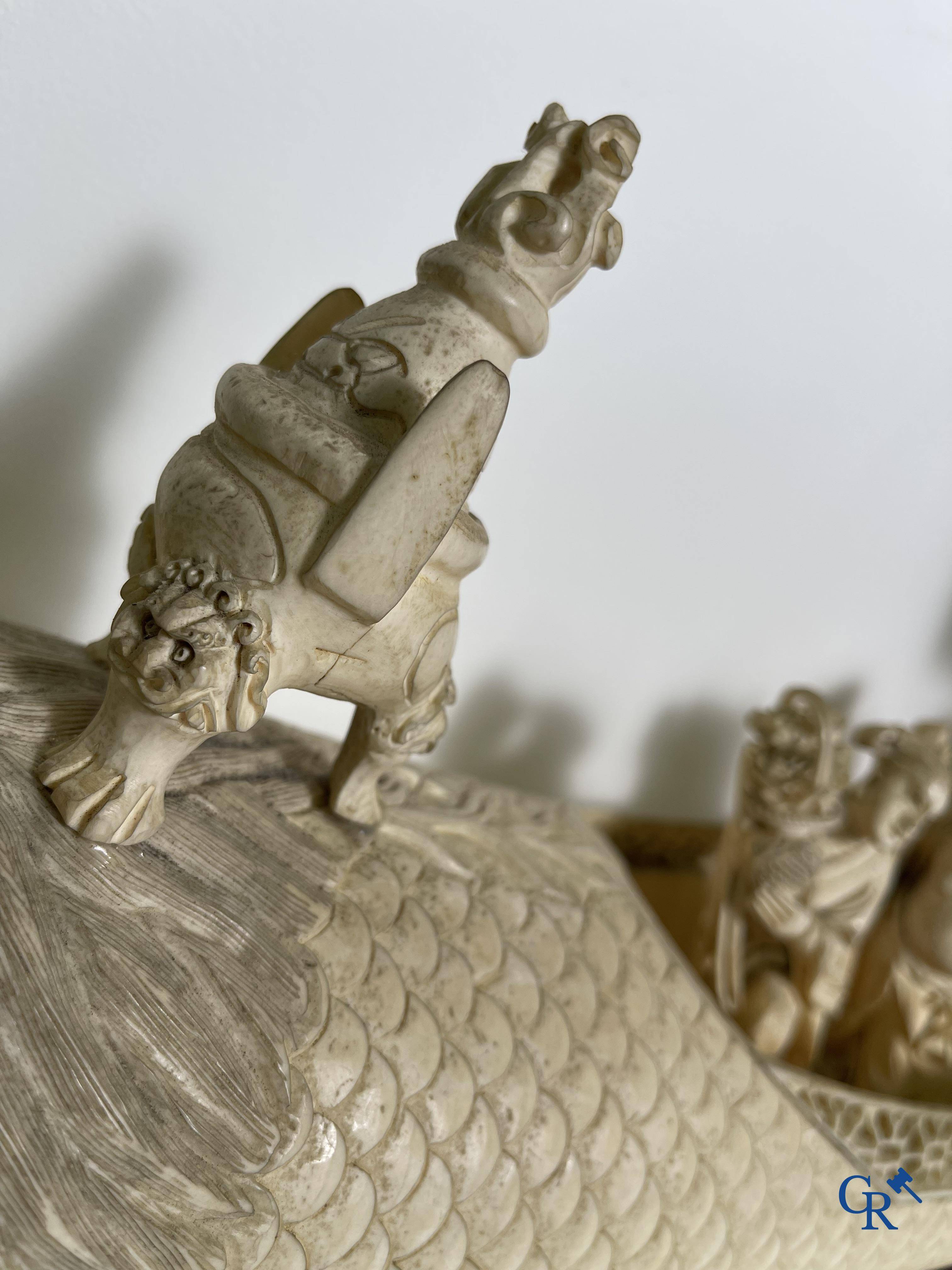 Asian Art: A large Chinese ivory dragon boat on a wooden pedestal. 19th century.