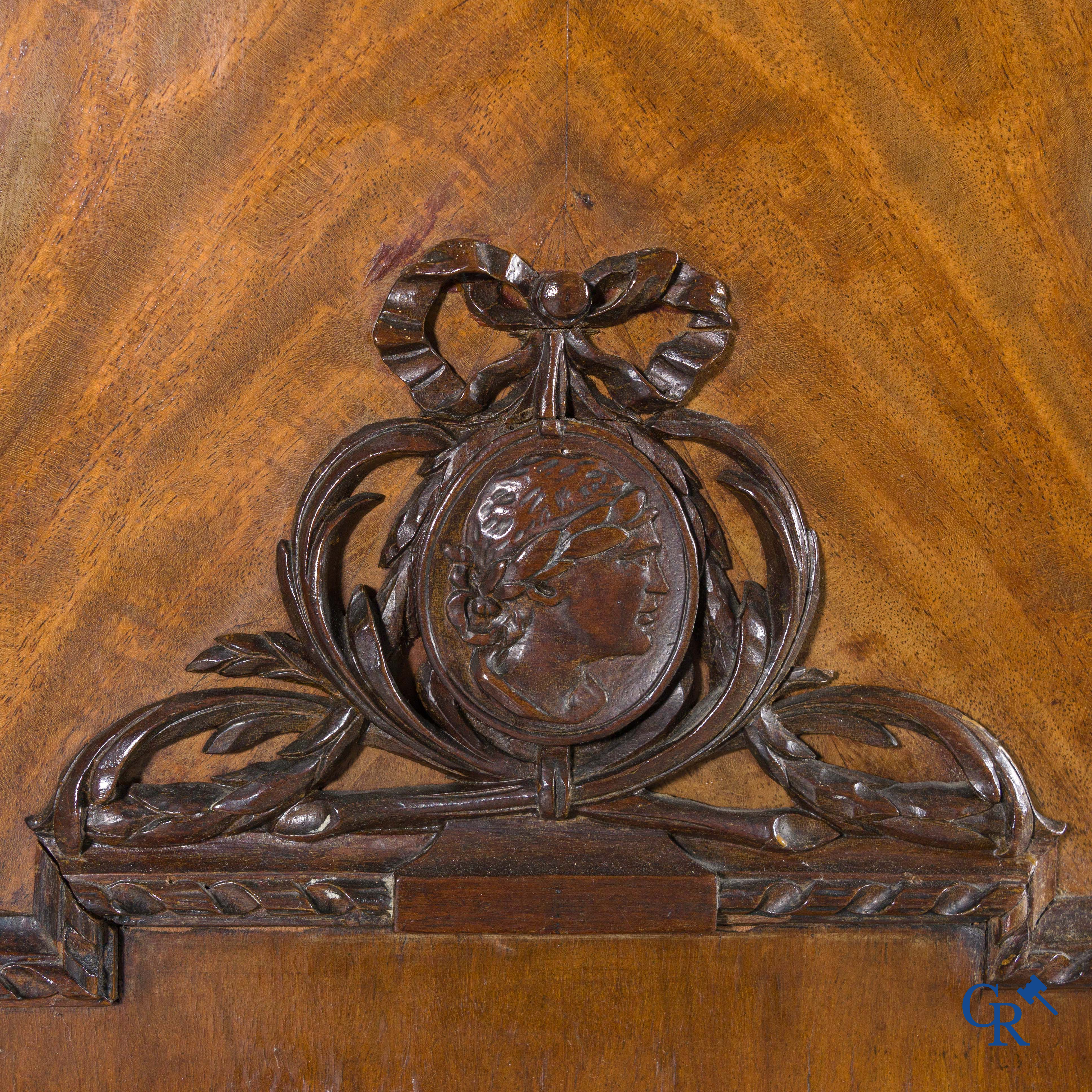 A large mahogany wooden cabinet with 3 drawers and 2 doors decorated with lockets. LXVI style.