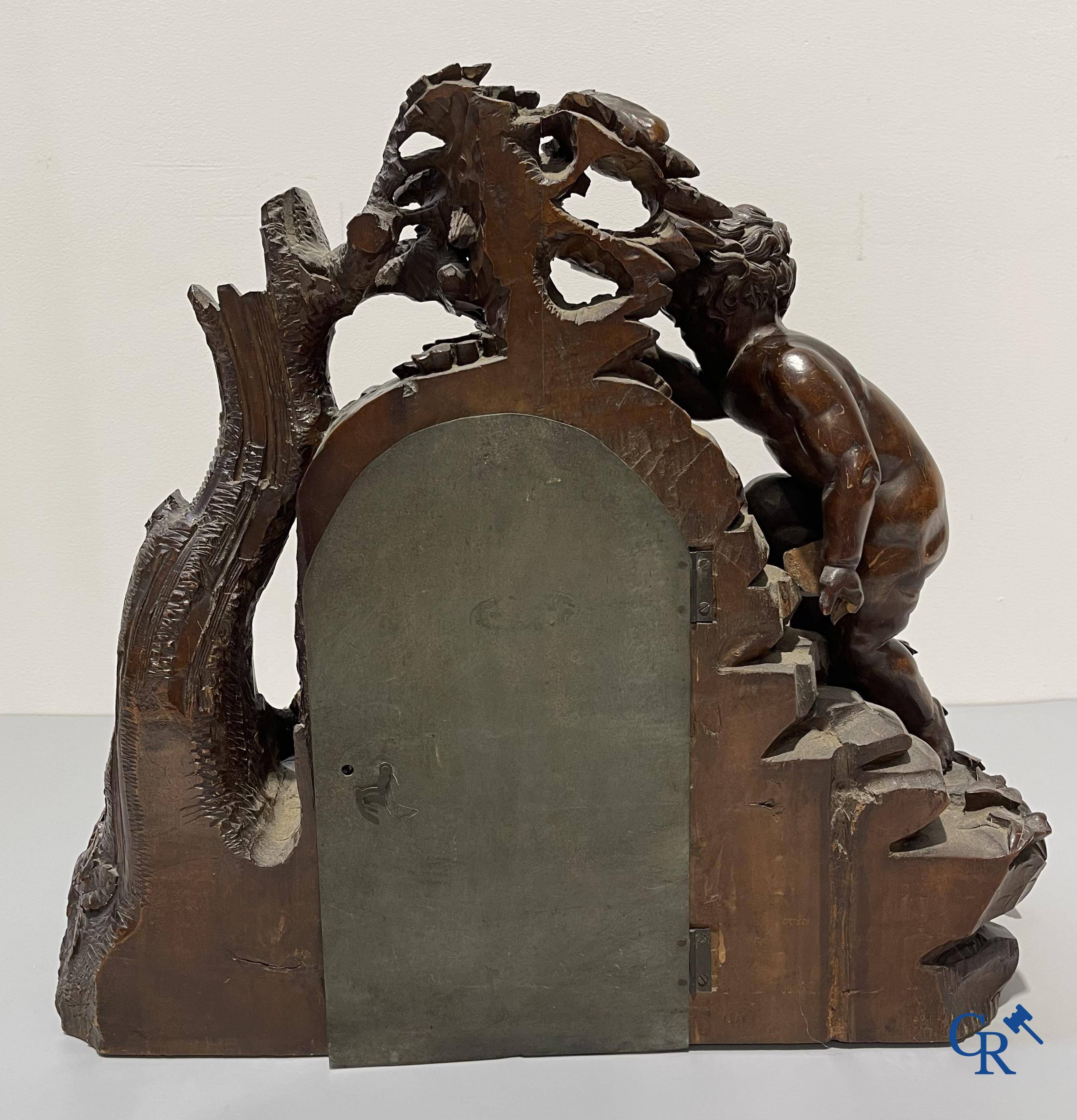 A finely carved walnut clock in so-called "black forest" carving. French work circa 1860-1880.