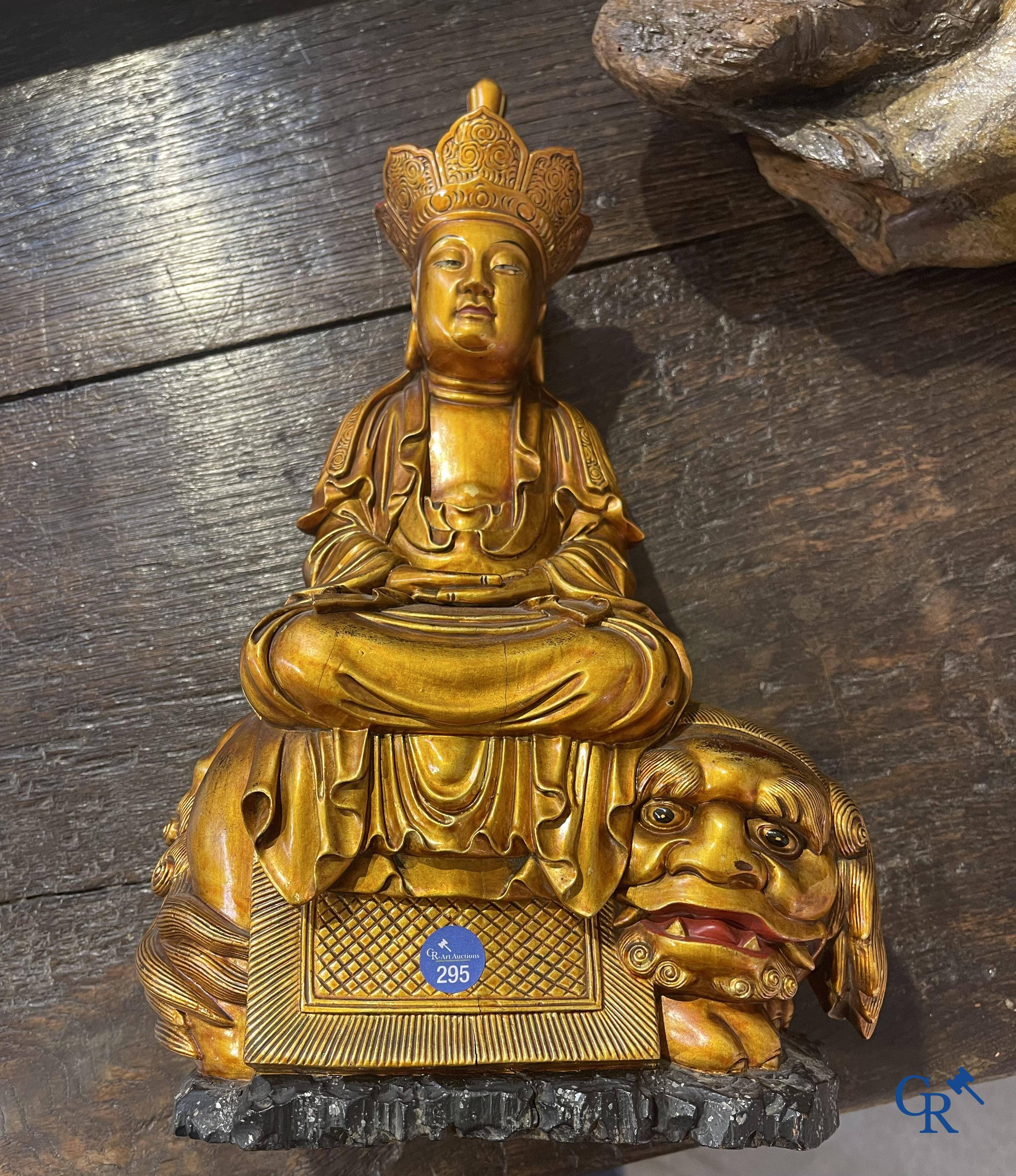 Asian Art: A Chinese sculpture of Vaishravana on a Buddhist lion in lacquered and gilded wood. 19th century.