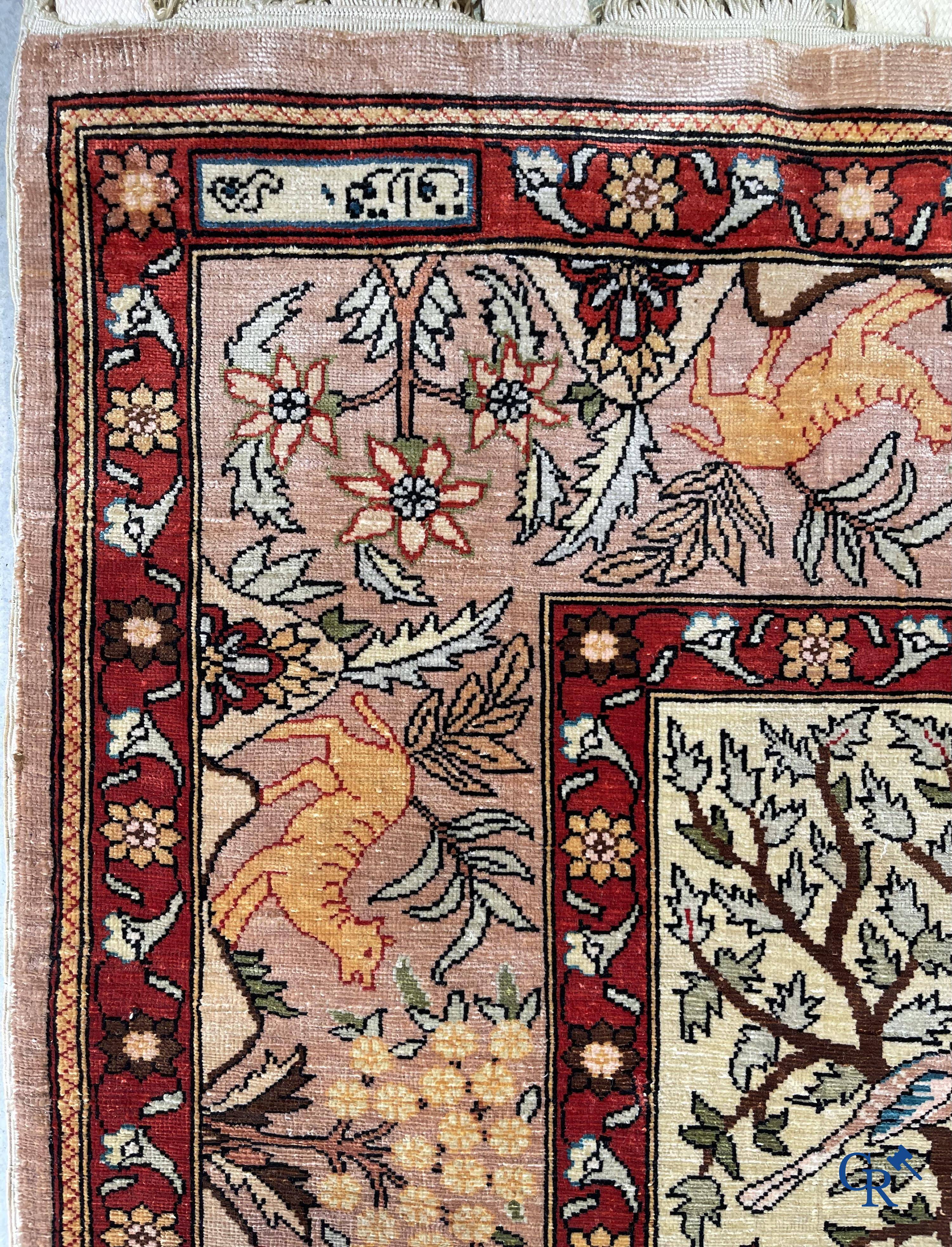 Oriental rugs, a fine hand-knotted silk tapestry with animals in a forest. Signed.