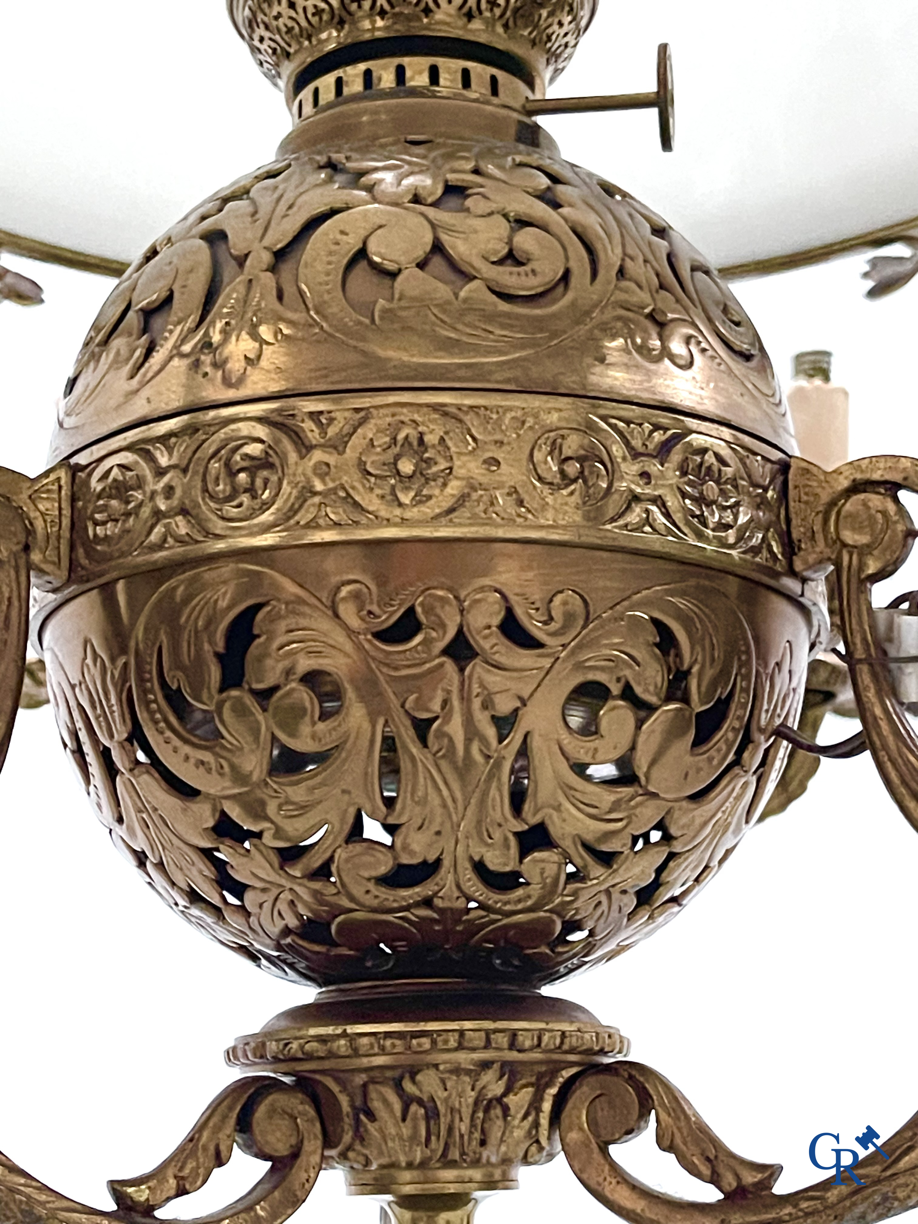 A lot of an imposing chandelier with 12 light points, a lamp belge with bronze frame and a fireplace piece.