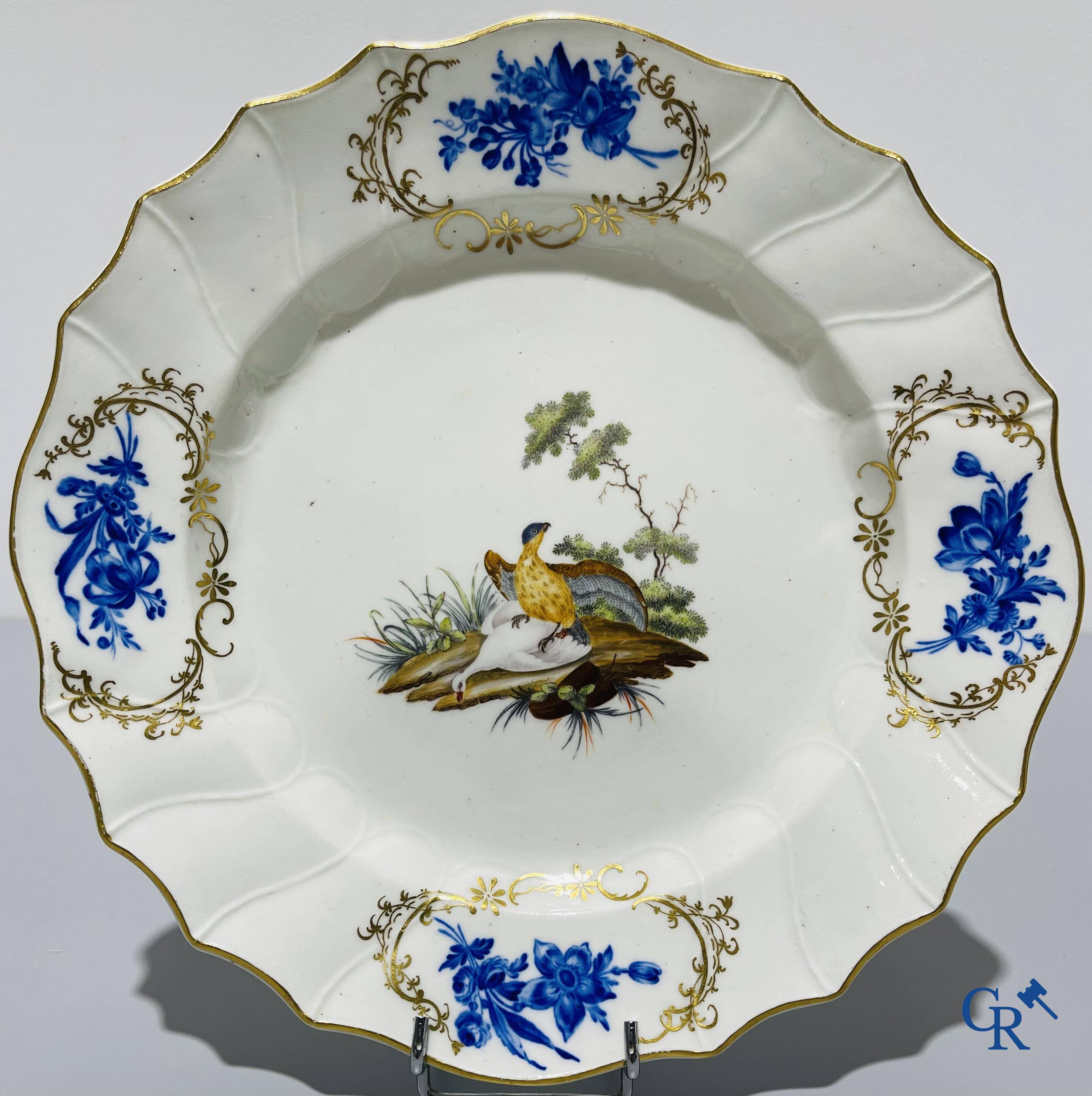 European porcelain, Tournai. 2 plates with a polychrome decoration of birds and gold decoration in The Hague. 18th century.