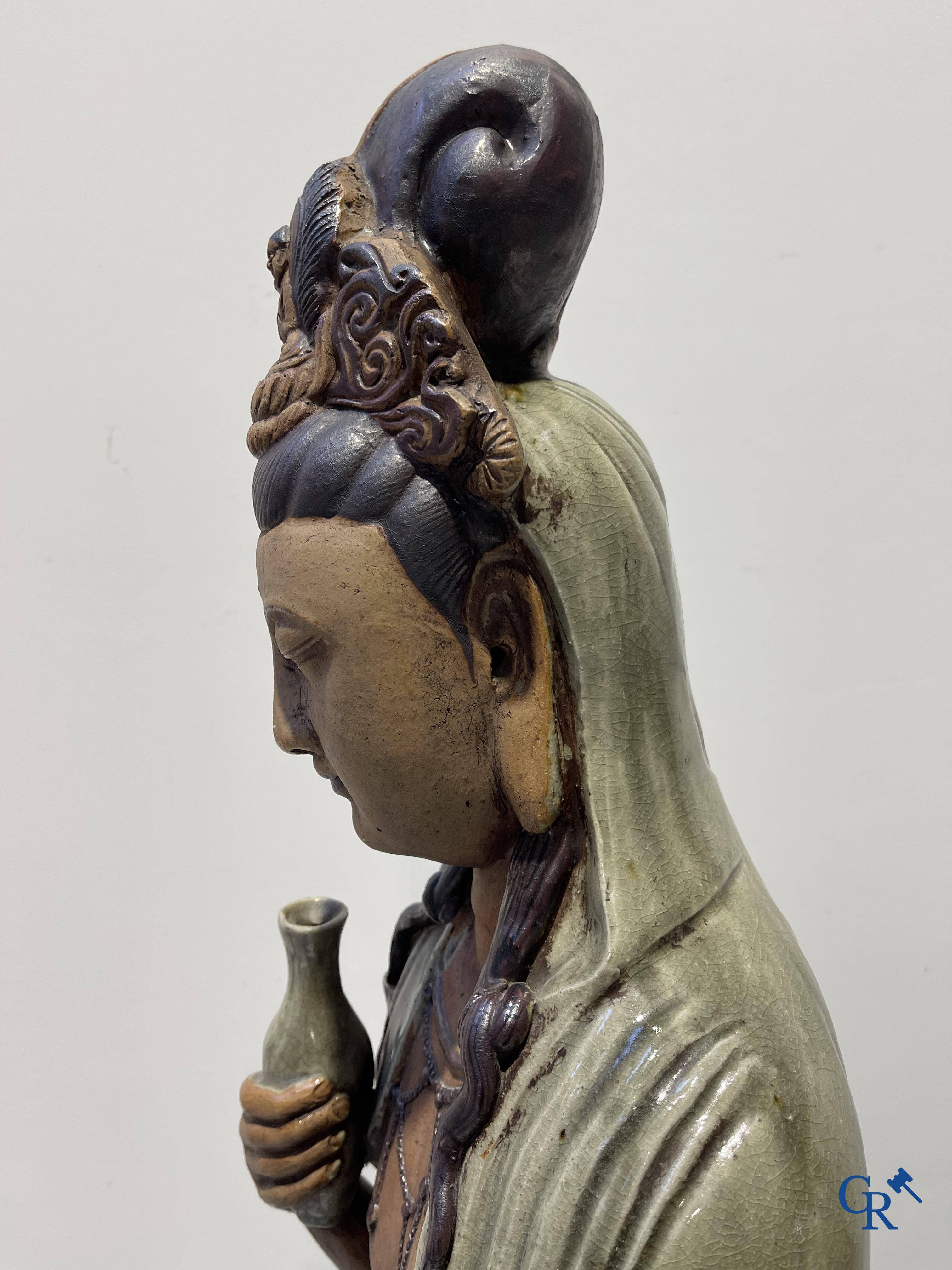 Asian Art, an imposing Shiwan earthenware figure of Guanyin.