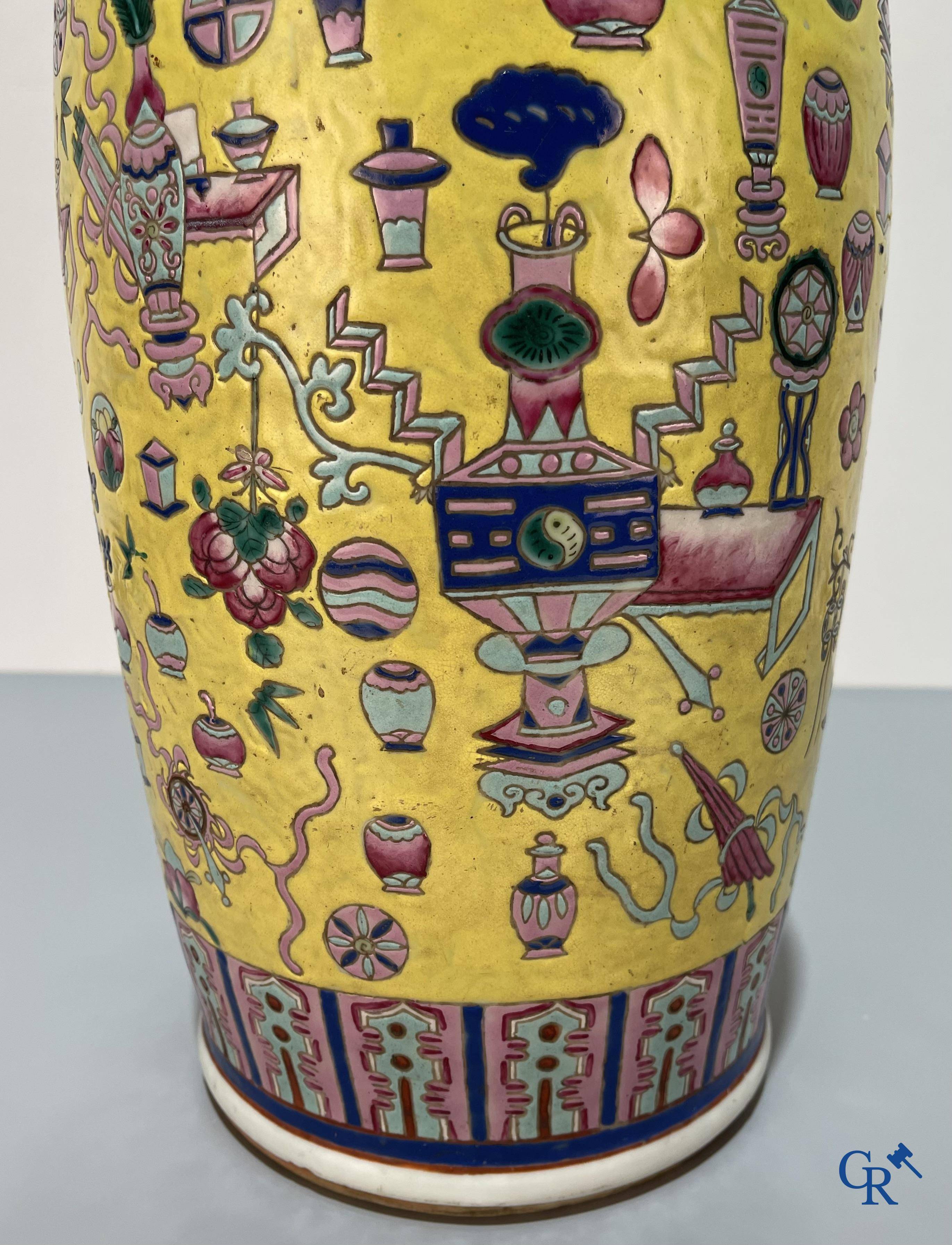 Asian Art, Chinese porcelain, a large Chinese famille jaune and rose vase with a decor of antiques. 19th century.