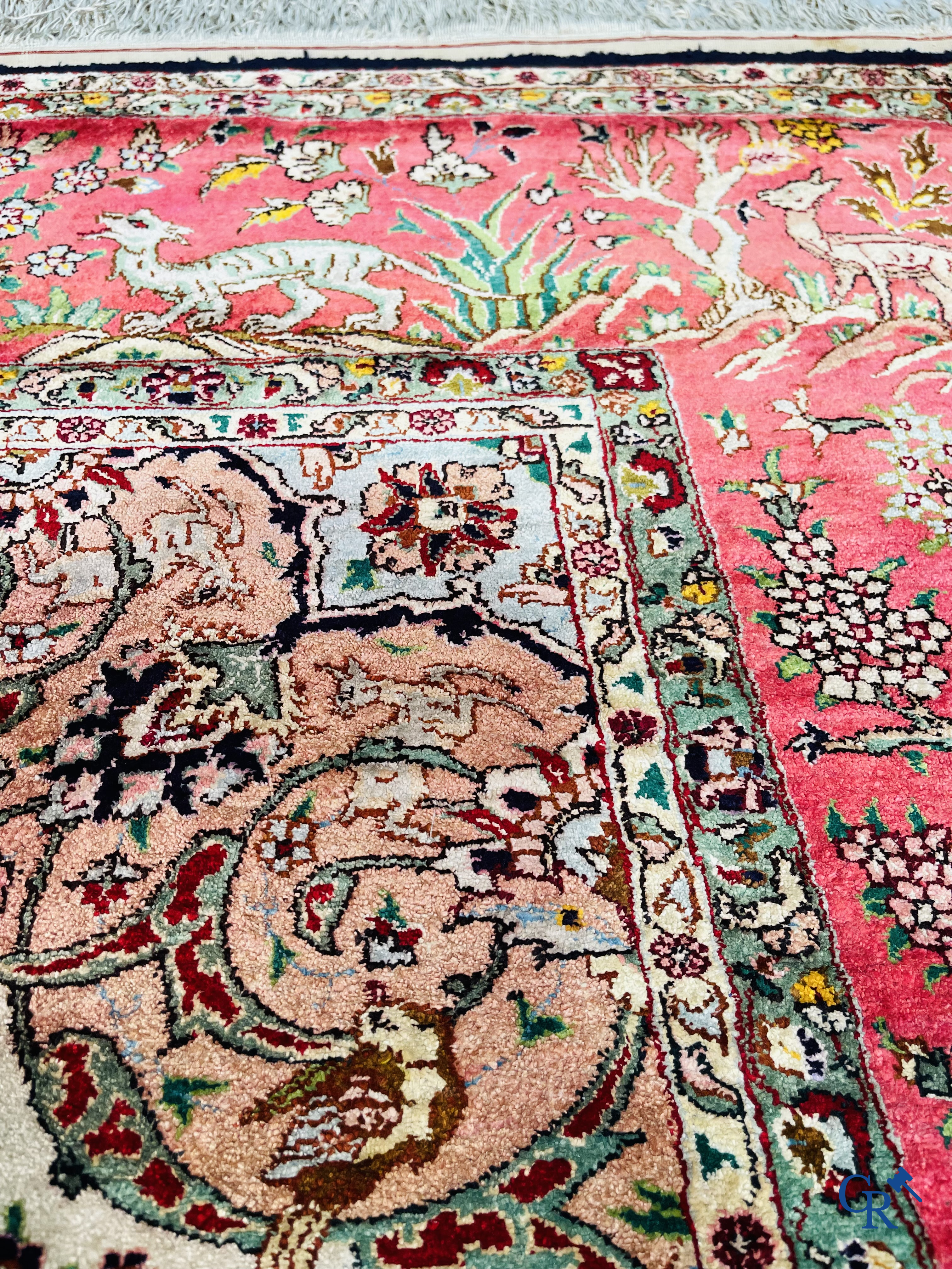Oriental carpets: Tabriz, a finely hand-knotted silk carpet with forest animals and birds in a floral decor.