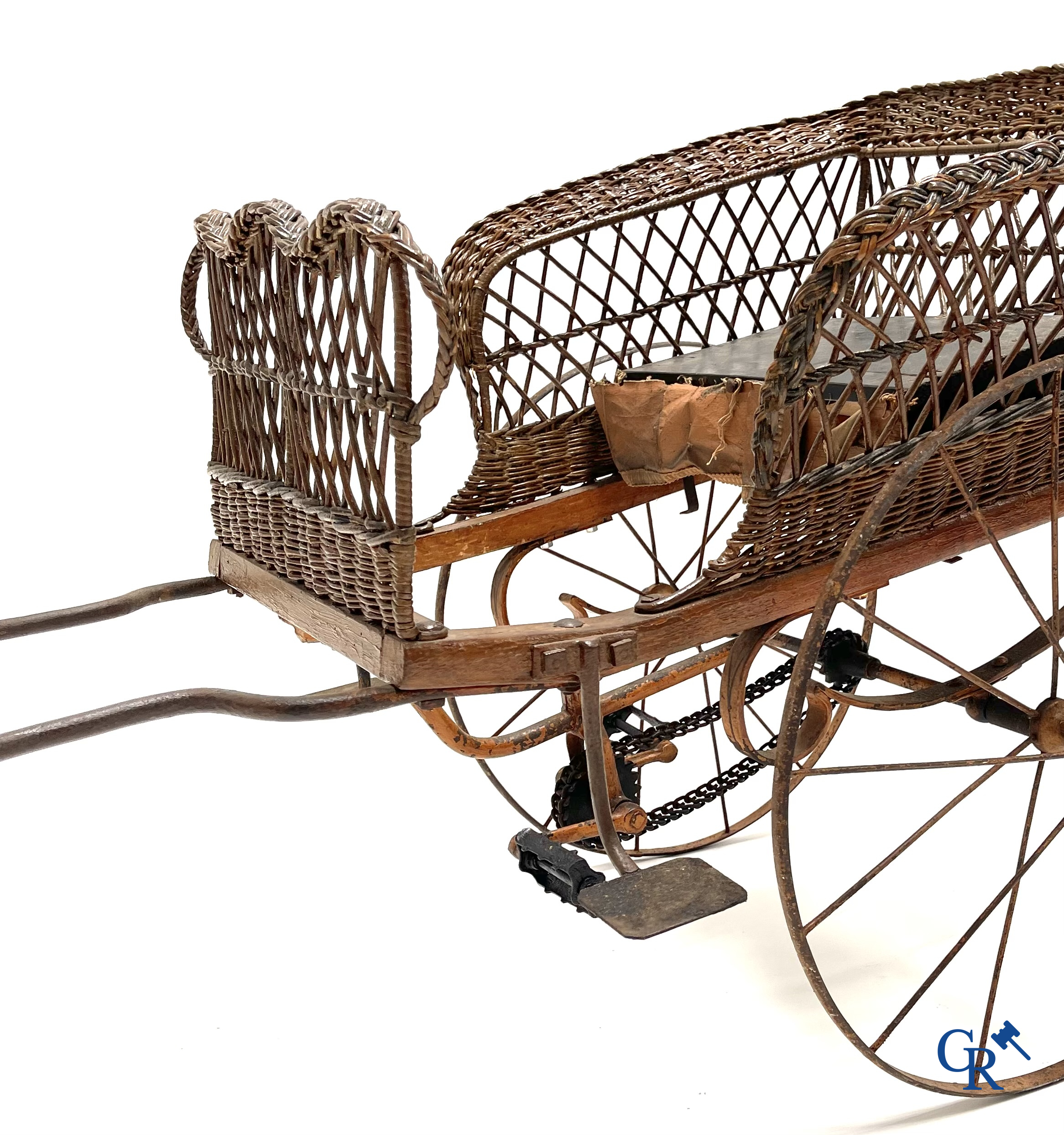 Zeldzame mechanische kinderkar in gevlochten riet en beschilderd metaal ontworpen door Peugeot. Circa 1900.