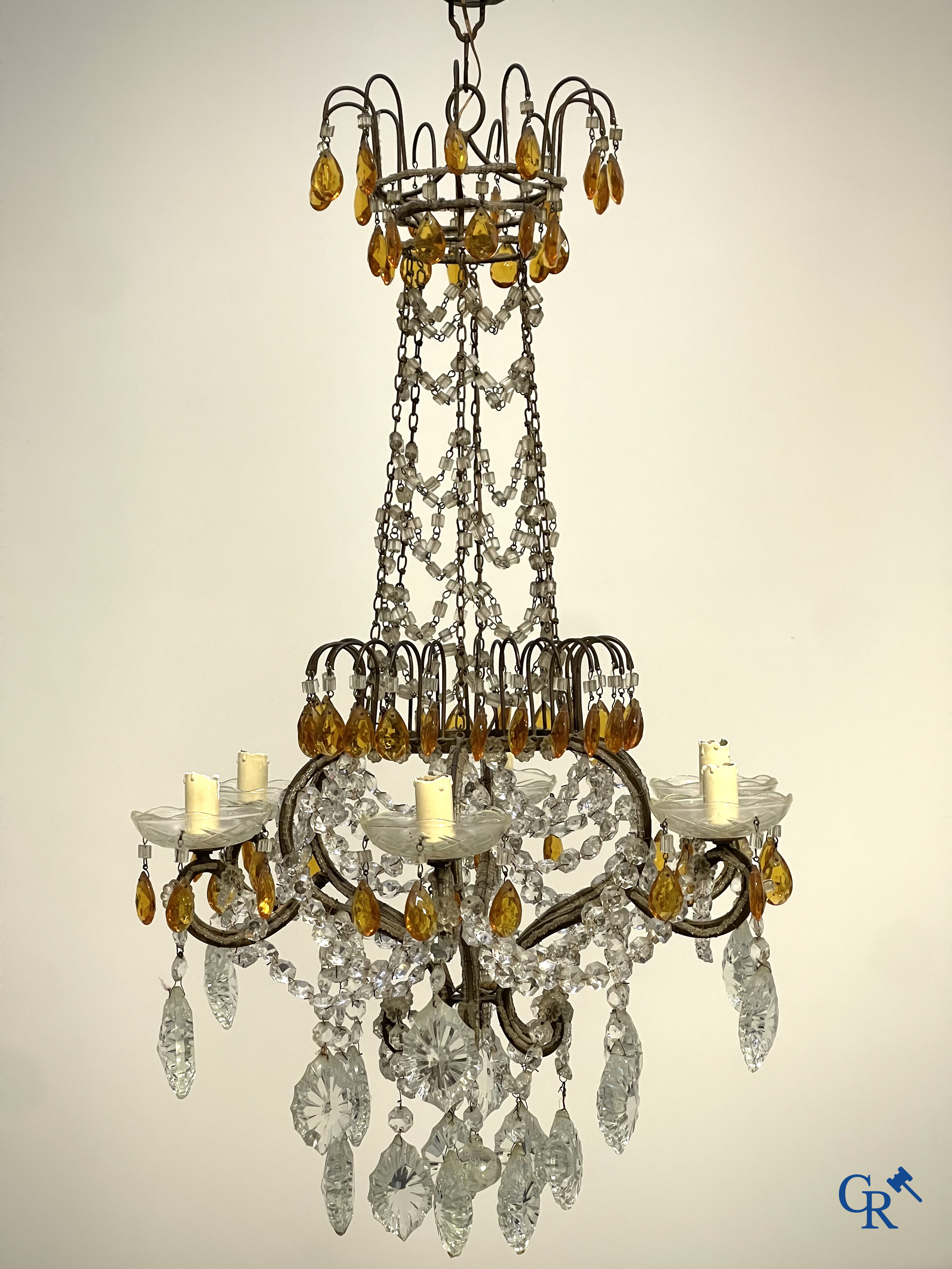 A large chandelier in crystal with double pearls on the frame.