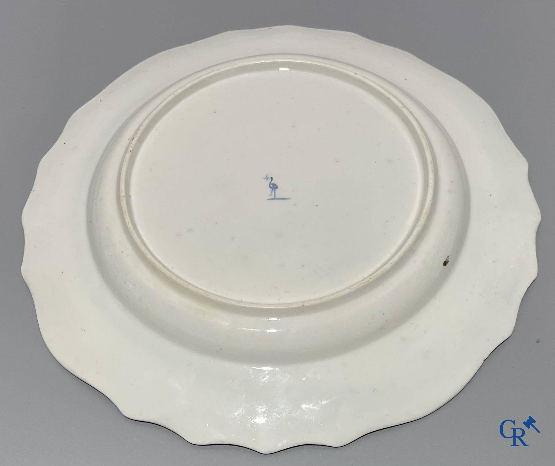 European porcelain, Tournai. 2 plates with a polychrome decoration of birds and gold decoration in The Hague. 18th century.