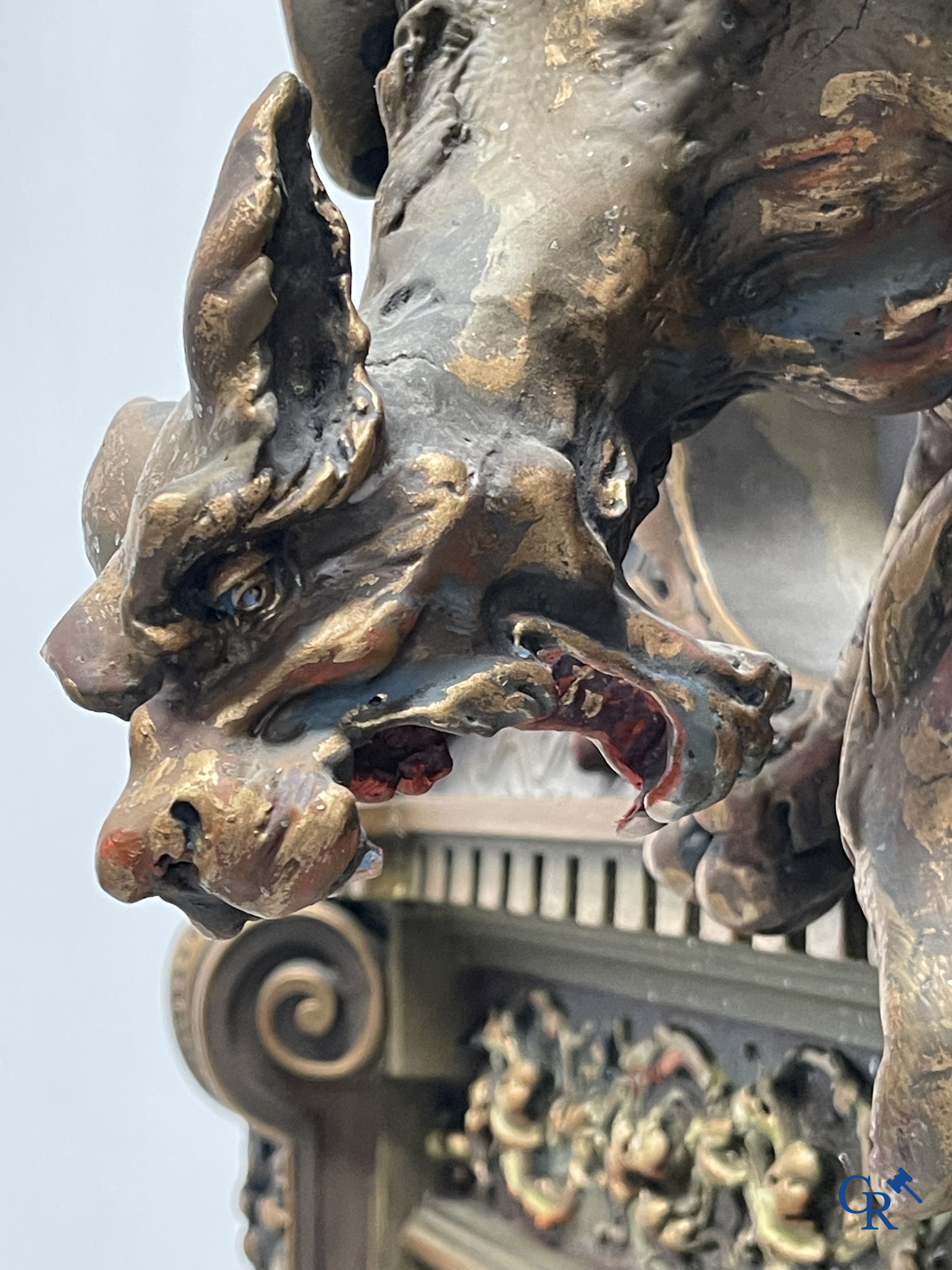 A large patinated fireplace mirror with a dragon. Around 1900.