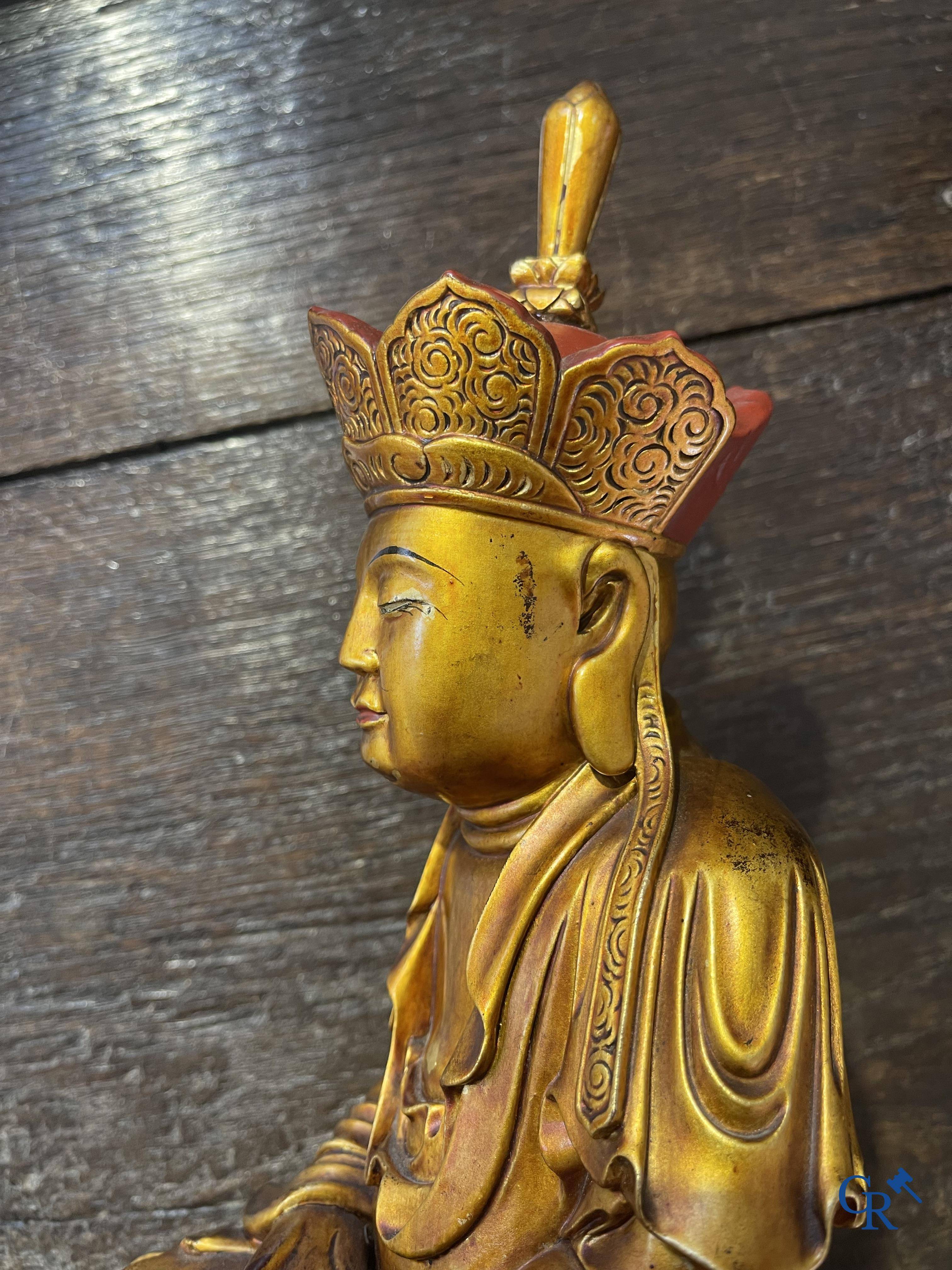 Asian Art: A Chinese sculpture of Vaishravana on a Buddhist lion in lacquered and gilded wood. 19th century.