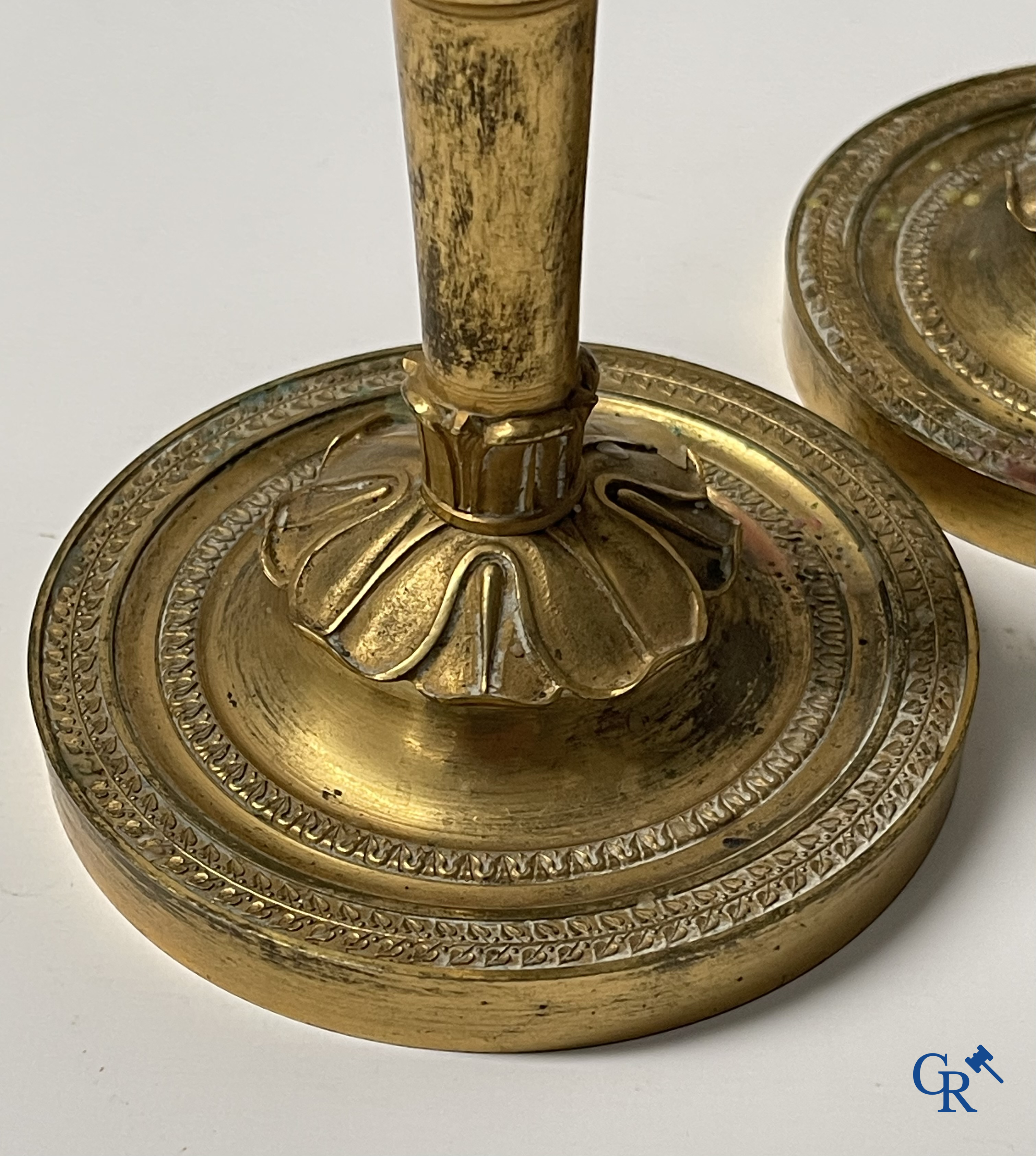 Empire era, a pair of finely chiseled and gilded bronze candlesticks. France, early 19th century.