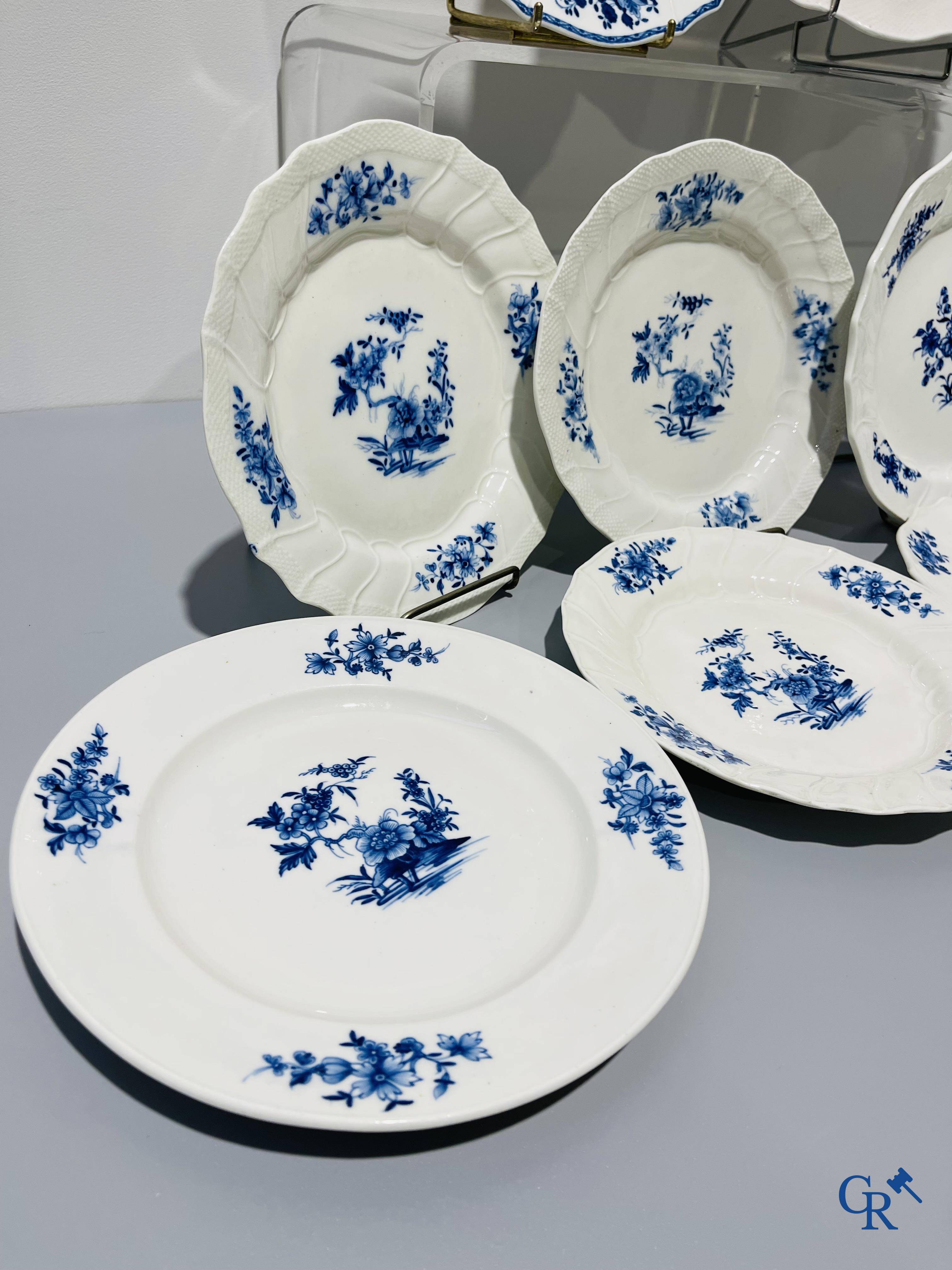 European porcelain, Tournai. 13 plates with blue decor and a large monochrome dish. 18th century.