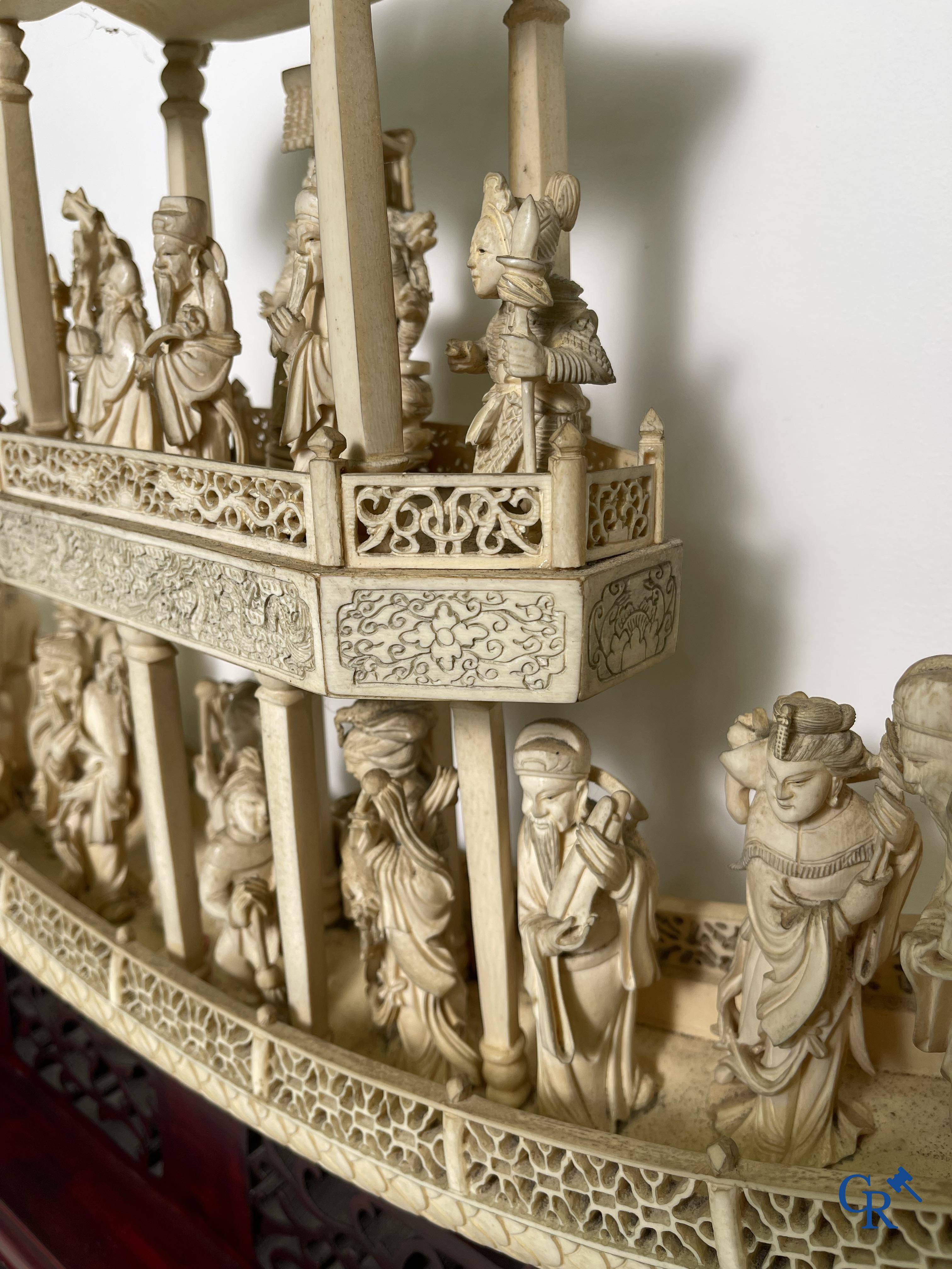 Asian Art: A large Chinese ivory dragon boat on a wooden pedestal. 19th century.