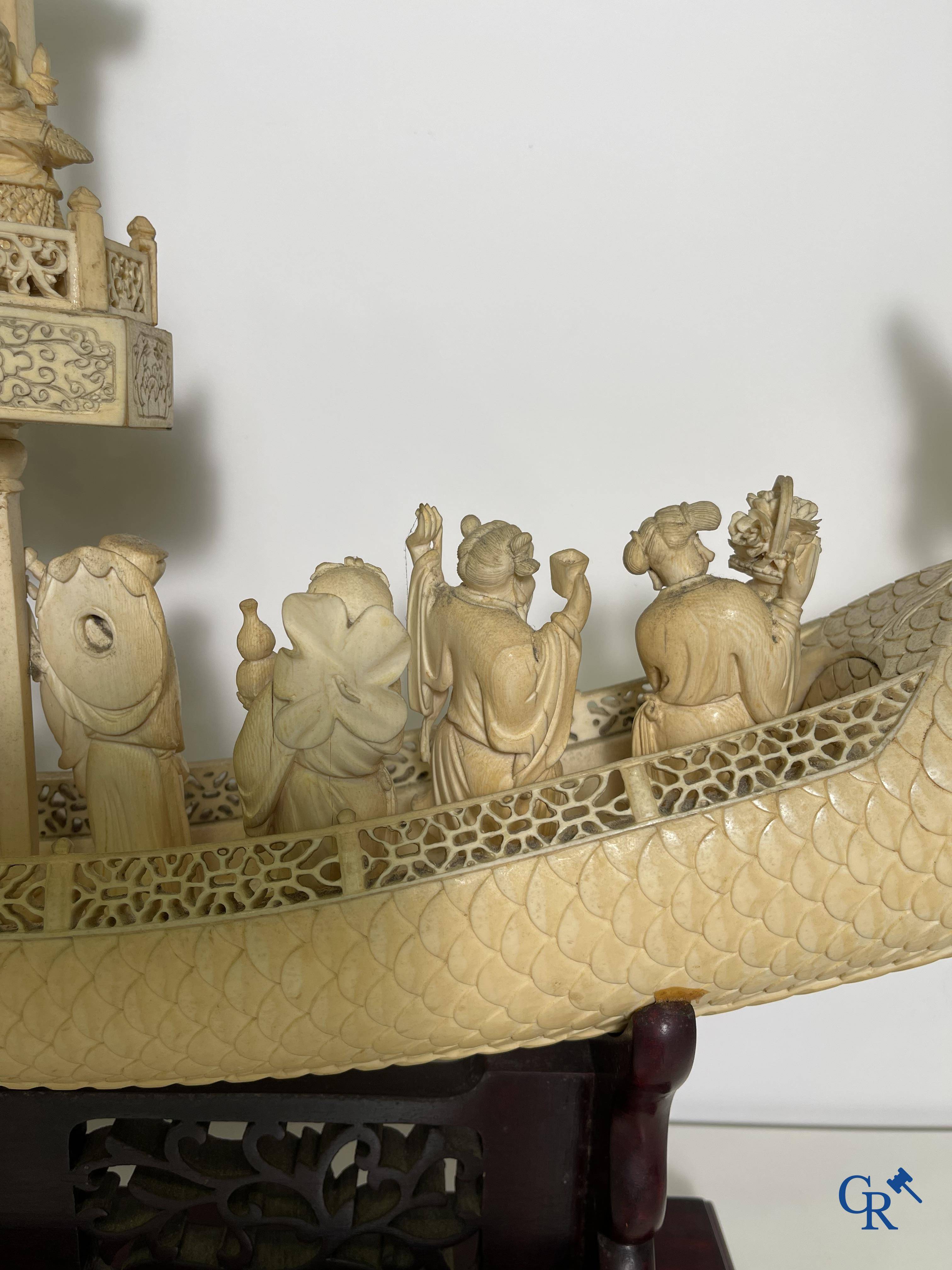 Asian Art: A large Chinese ivory dragon boat on a wooden pedestal. 19th century.