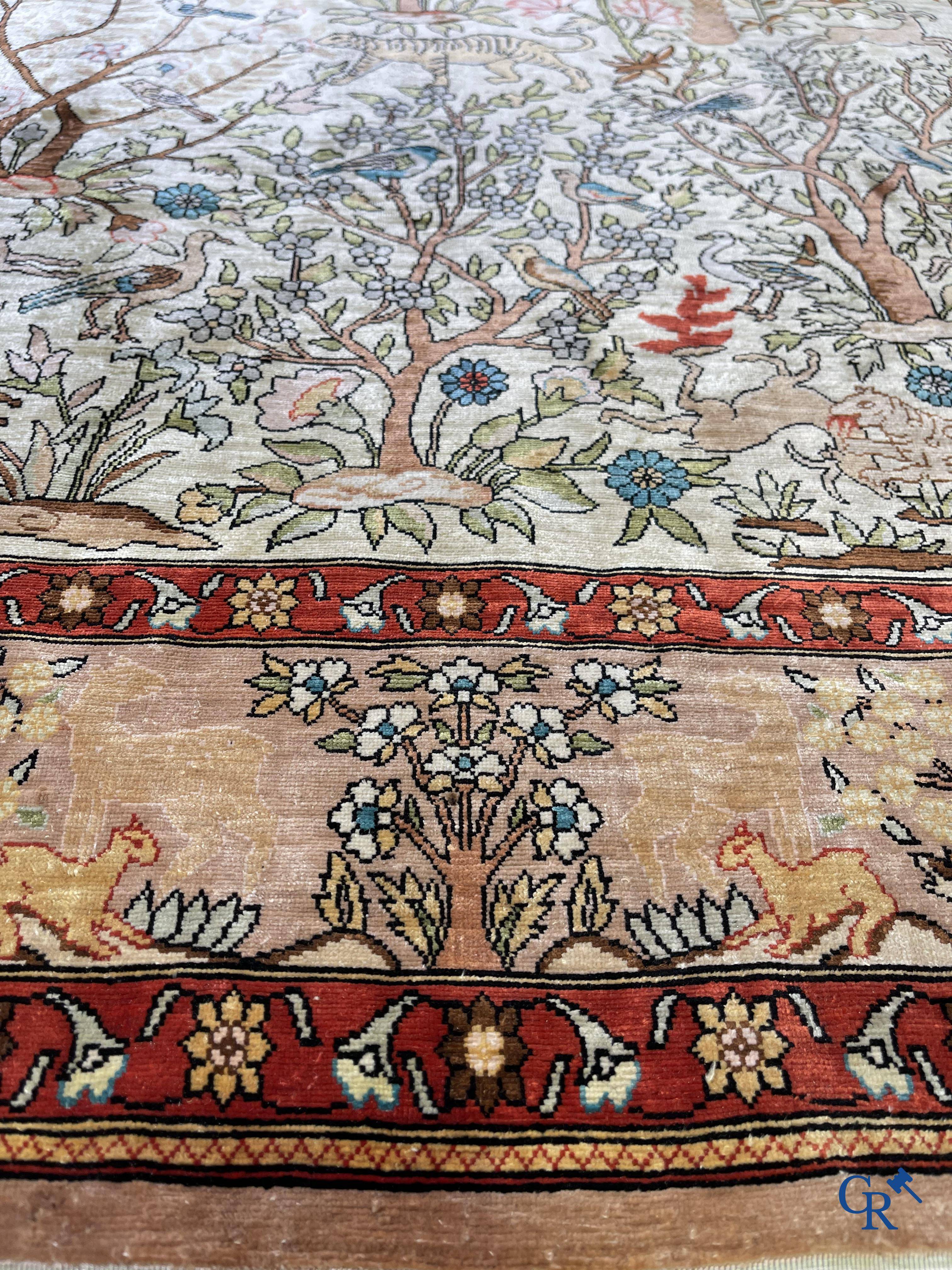 Oriental rugs, a fine hand-knotted silk tapestry with animals in a forest. Signed.