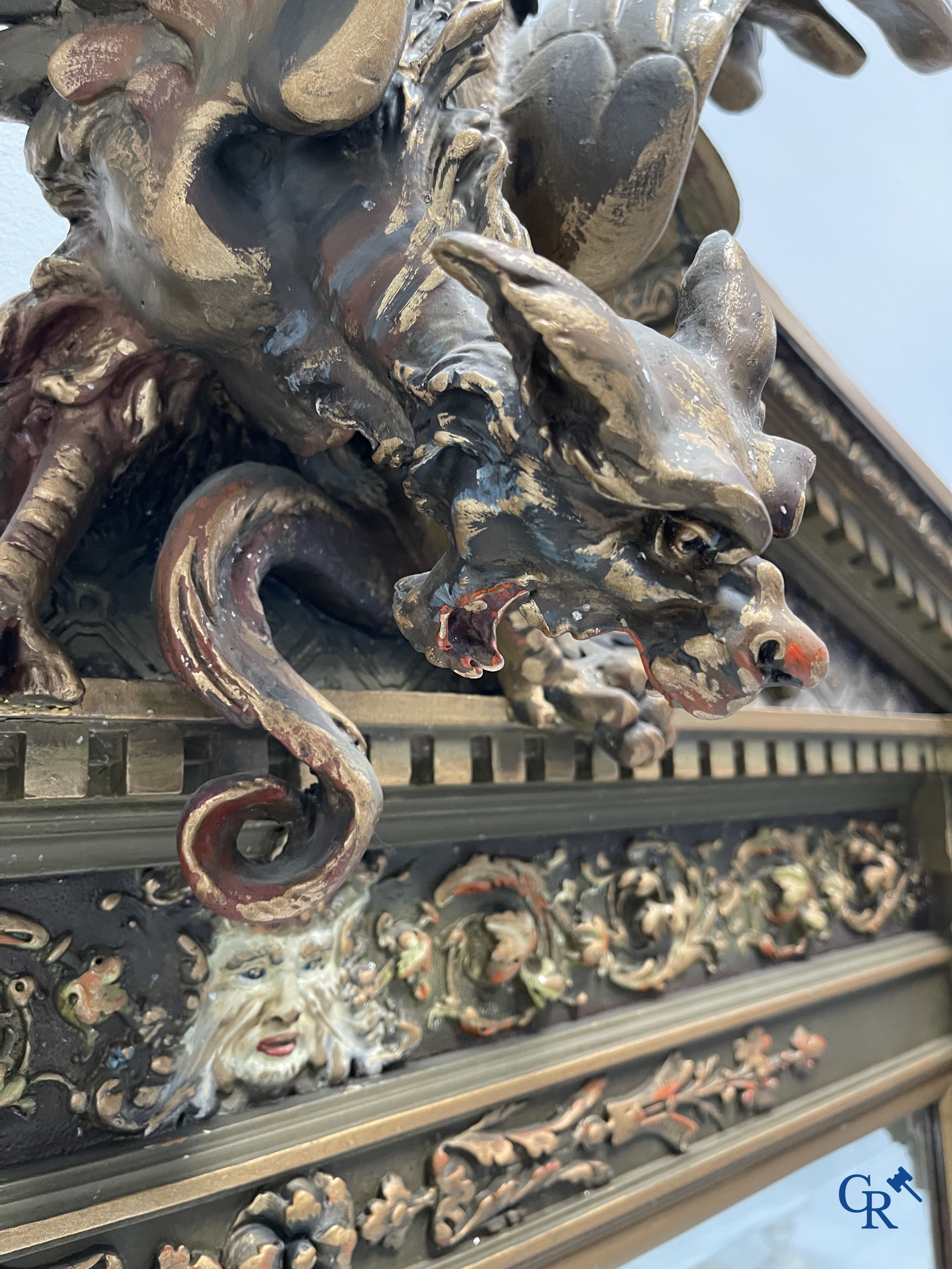 A large patinated fireplace mirror with a dragon. Around 1900.