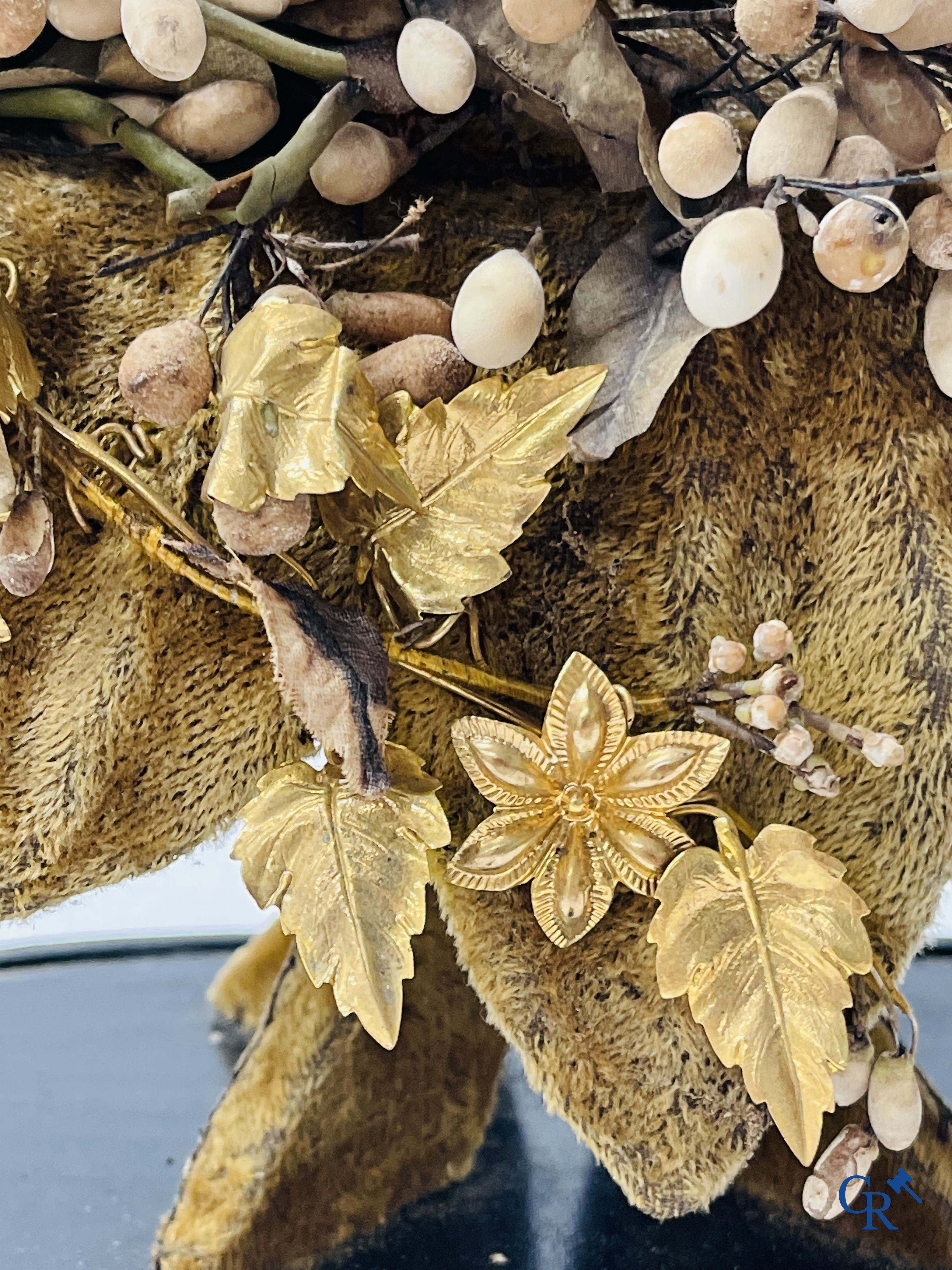 2 glass domes with a bridal bouquet on a base decorated with ornaments in gilded brass. circa 1900.