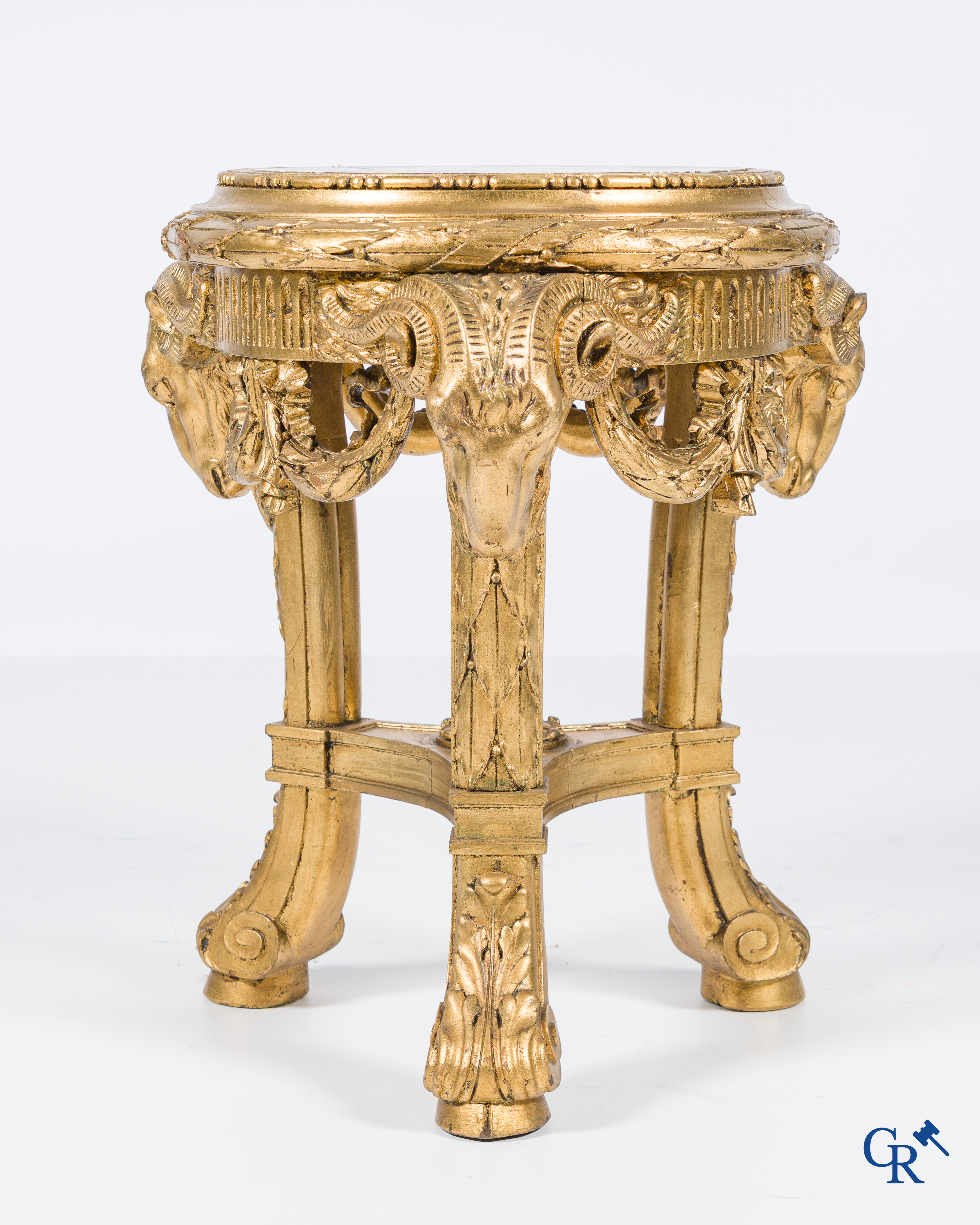 A large wood carved and gilded plinth with ram heads and garlands. LXVI style, circa 1900.