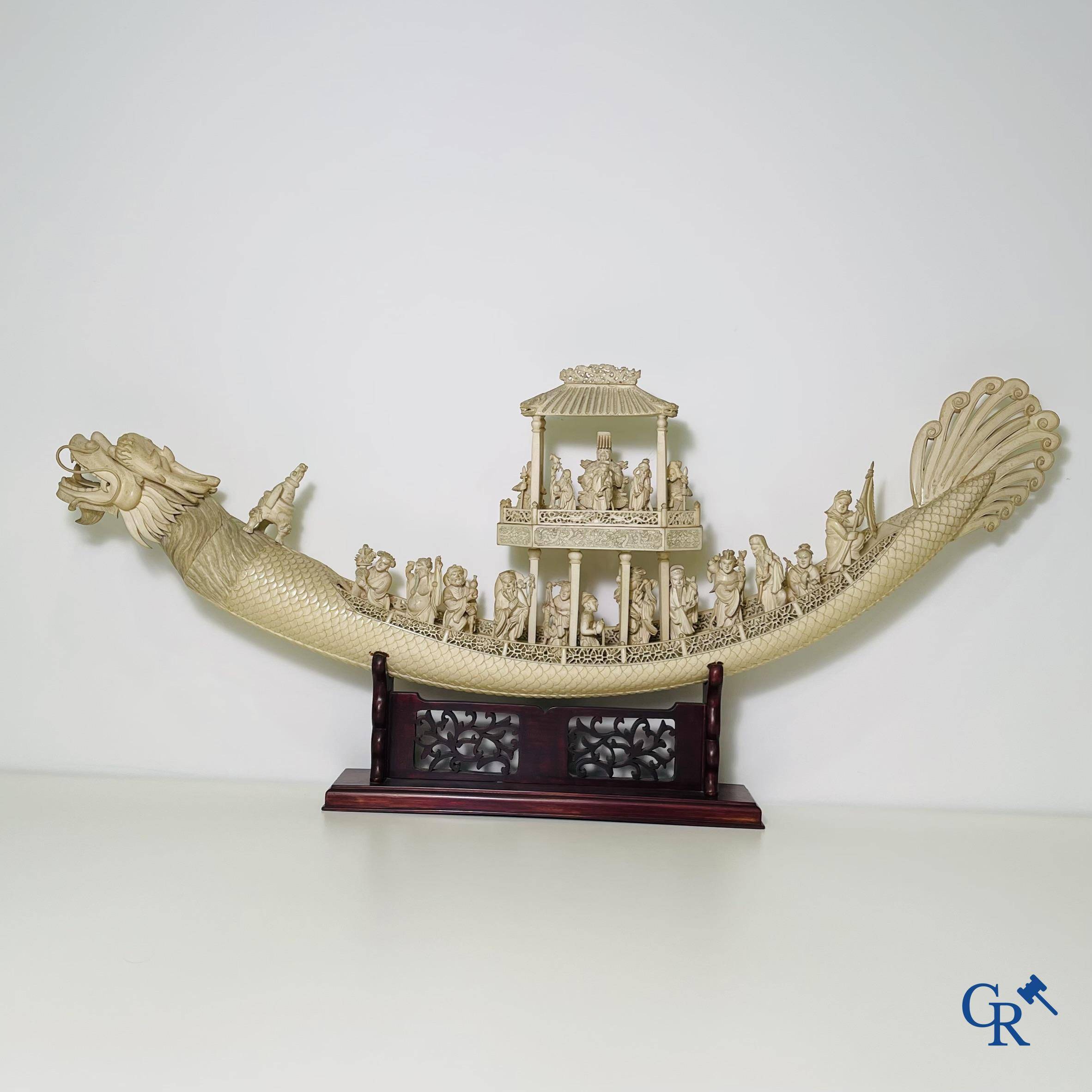 Asian Art: A large Chinese ivory dragon boat on a wooden pedestal. 19th century.