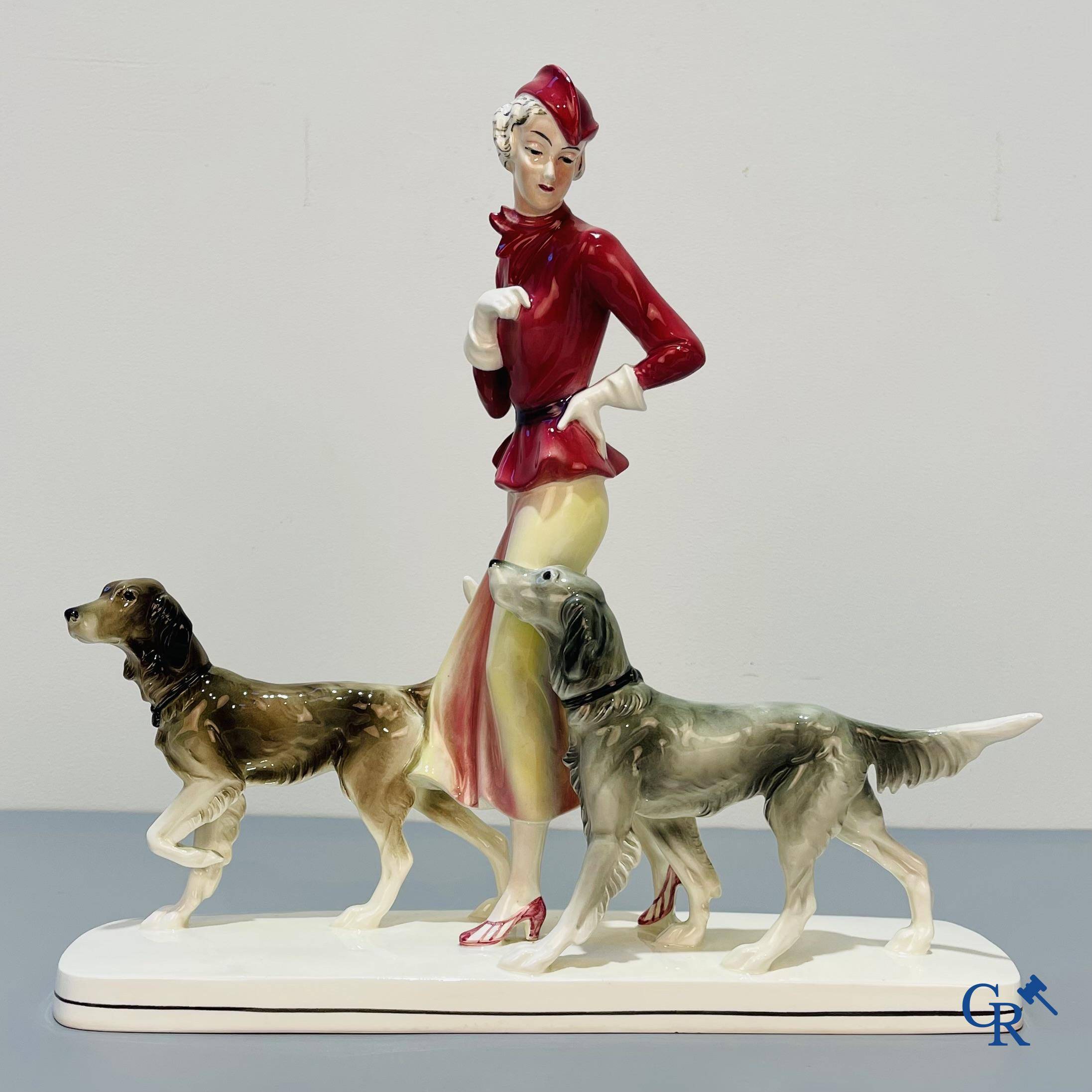 European porcelain, Katzhutte Hertwig, an Art Deco statue of a lady with dogs. Marked and numbered 74.
