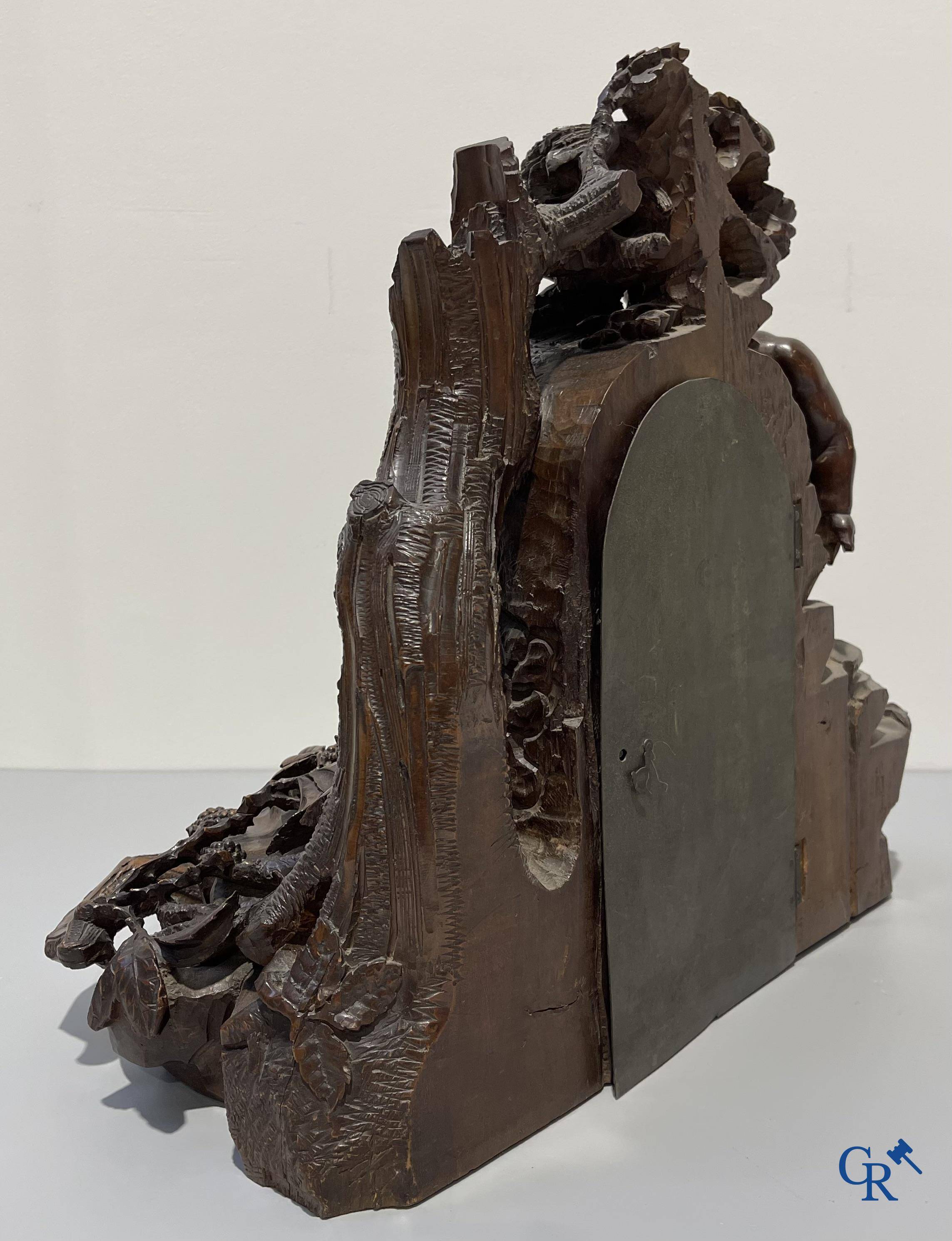 A finely carved walnut clock in so-called "black forest" carving. French work circa 1860-1880.
